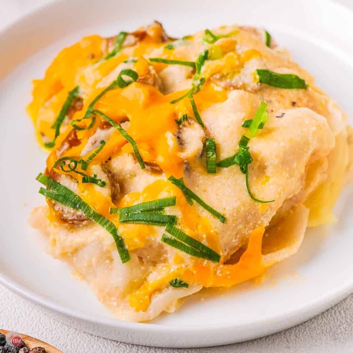 plate of pierogi casserole with sliced green onions on top