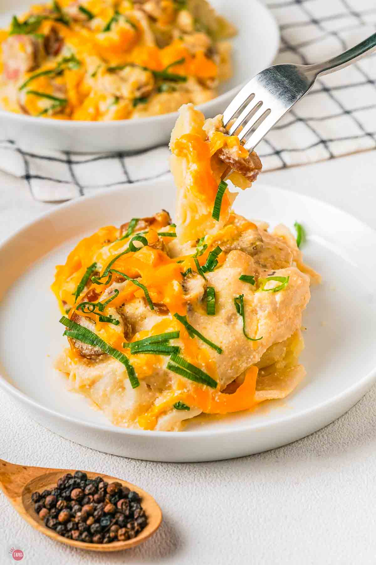 fork with a bite of pierogi and cheese