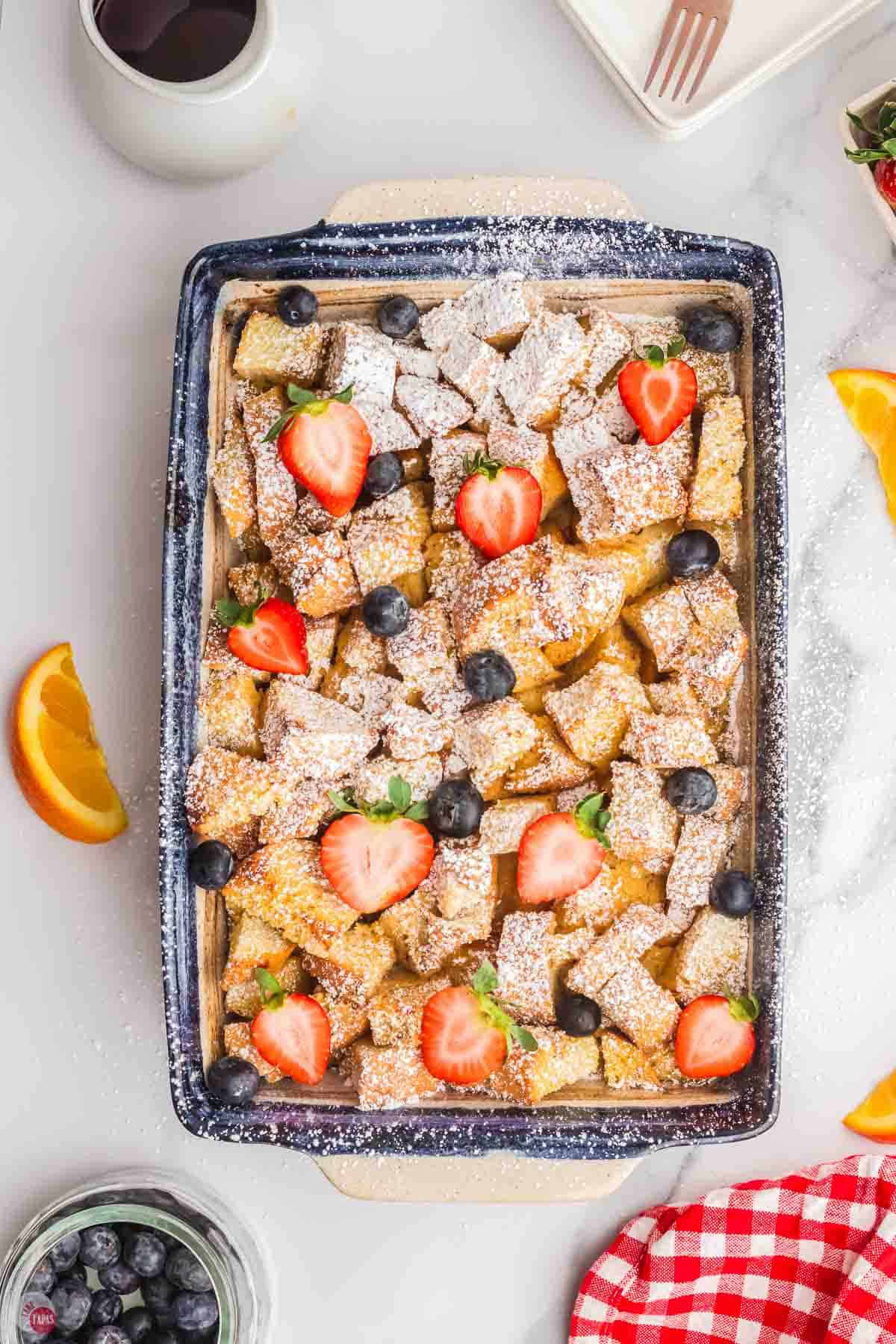 cubed bread with berries and powdered sugar
