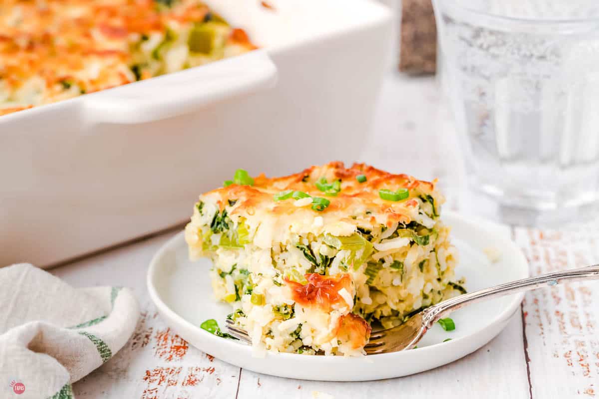 fork and bite on a plate with rice and spinach