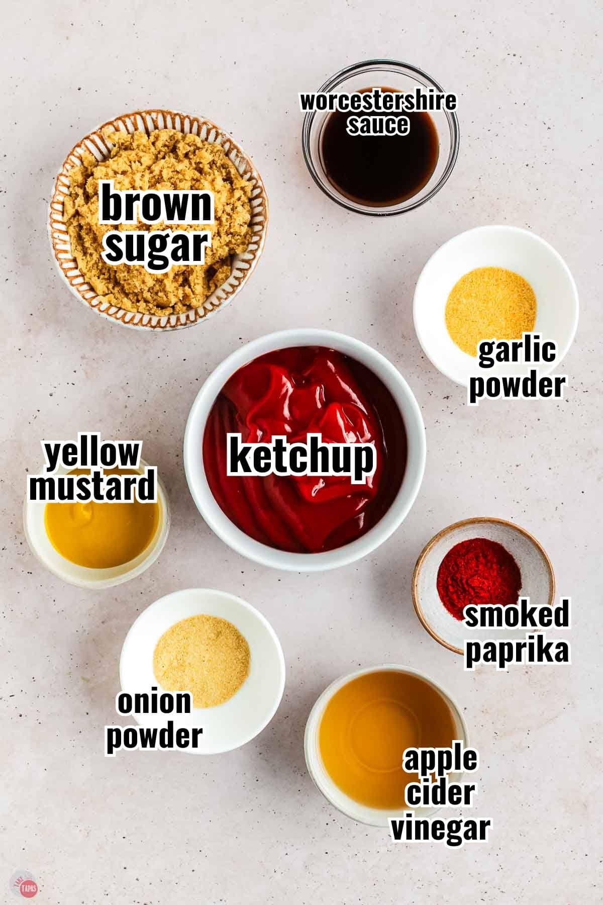 ingredients for bbq sauce in individual bowls with text overlay labeling them