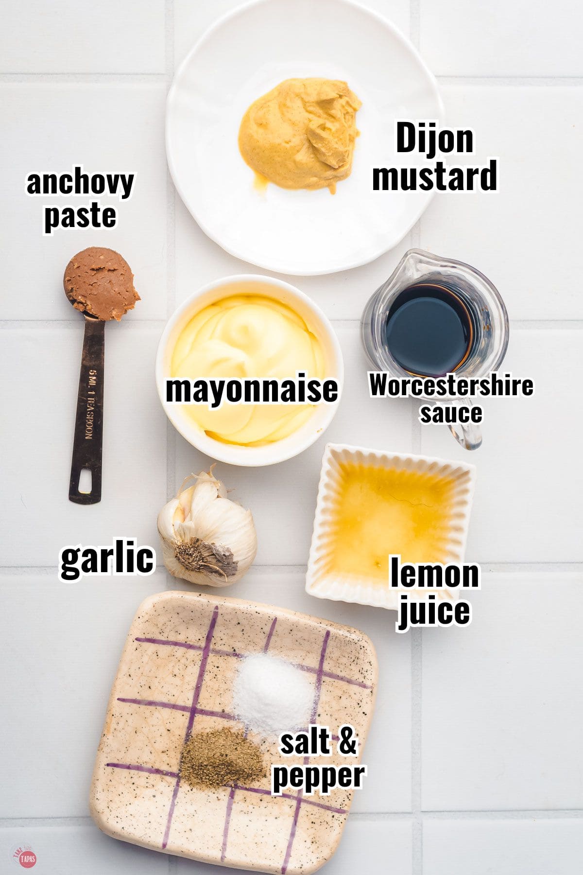 ingredients for a homemade salad dressing individual bowls with text overlay labeling them