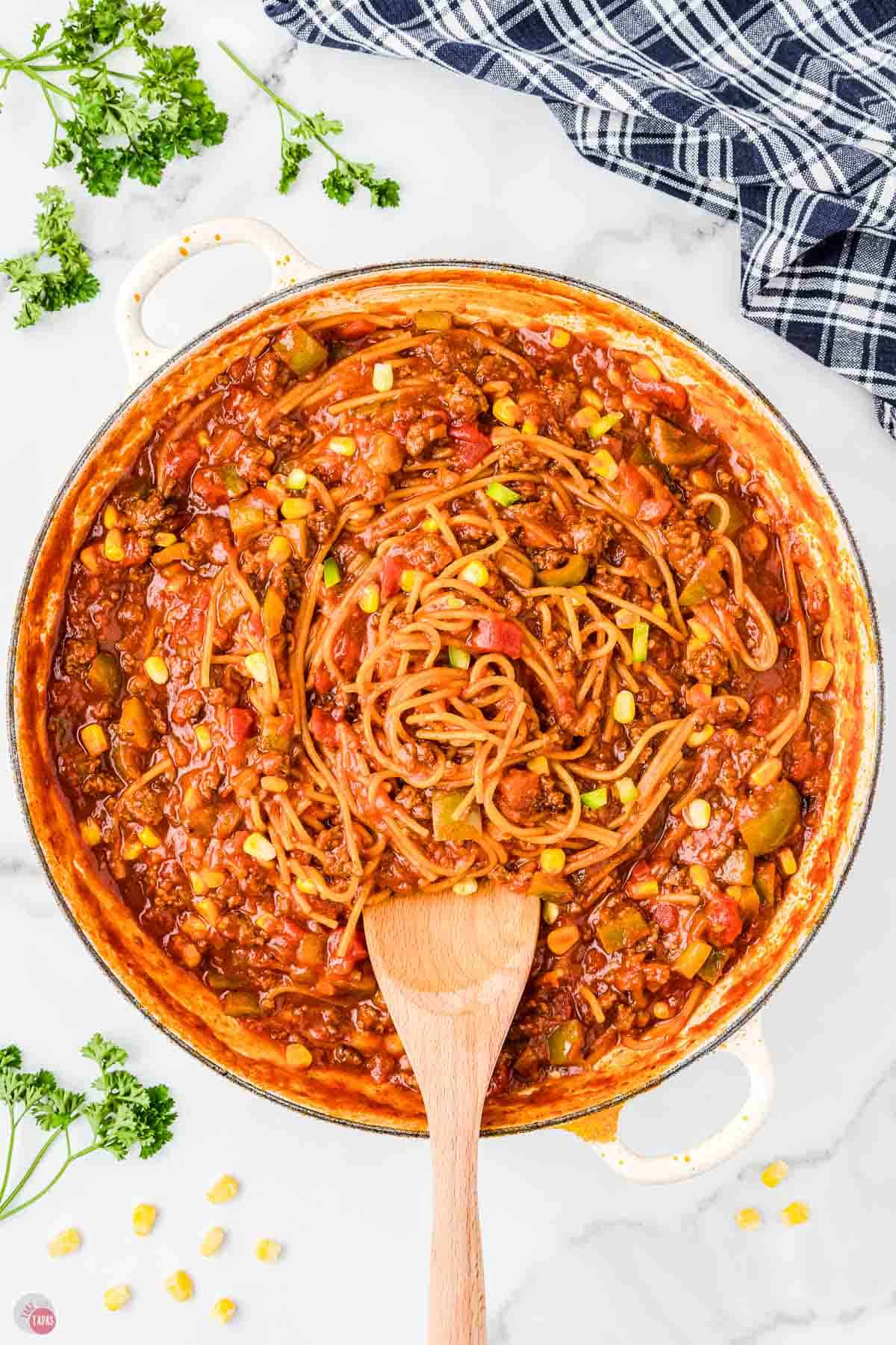 spaghetti and sauce in a white skillet