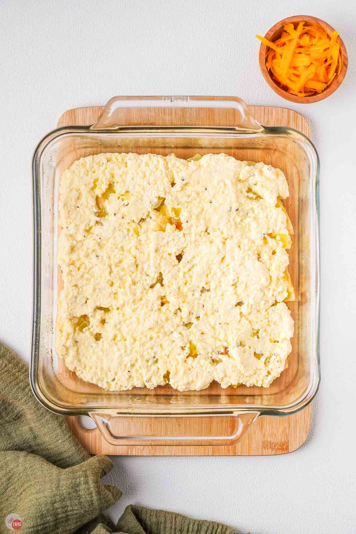 clear square dish with cheese in it