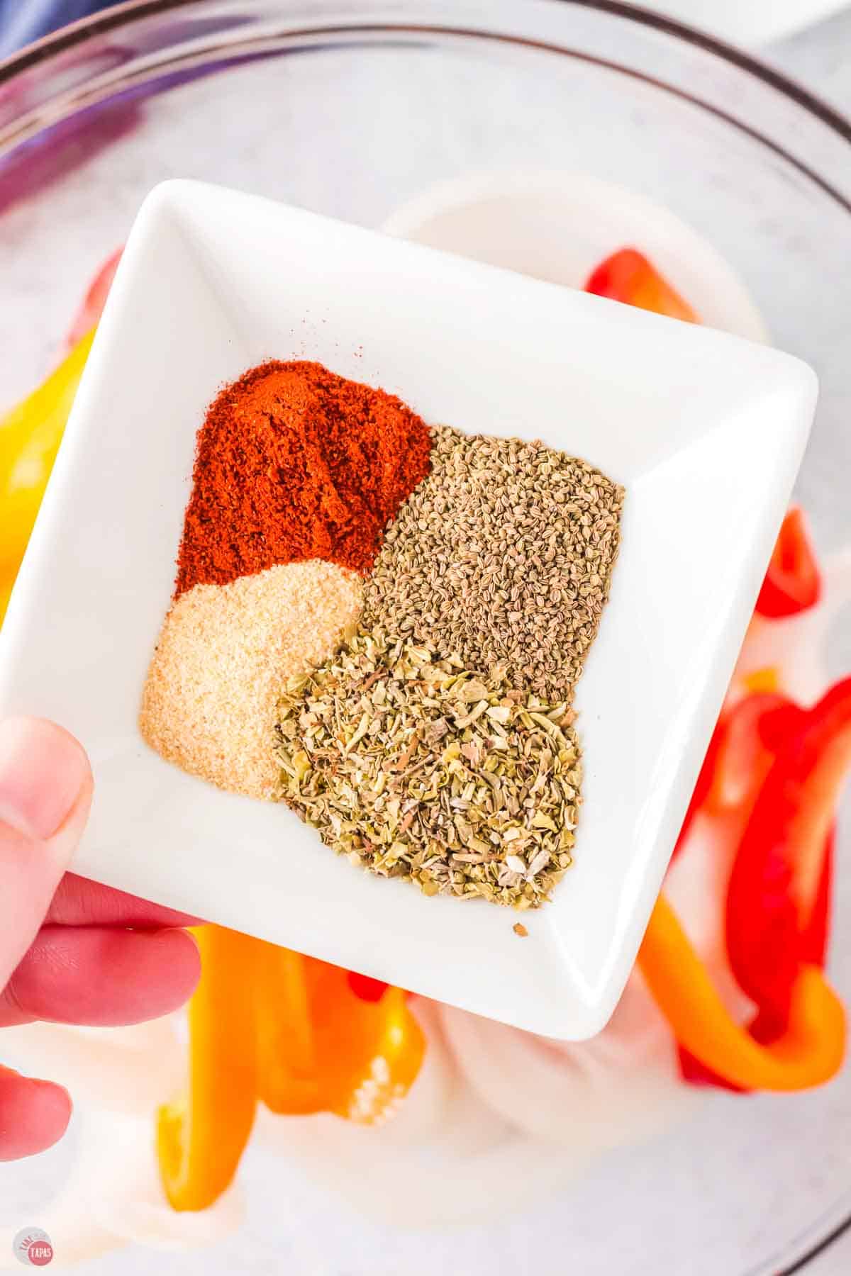 4 spices in a square white bowl