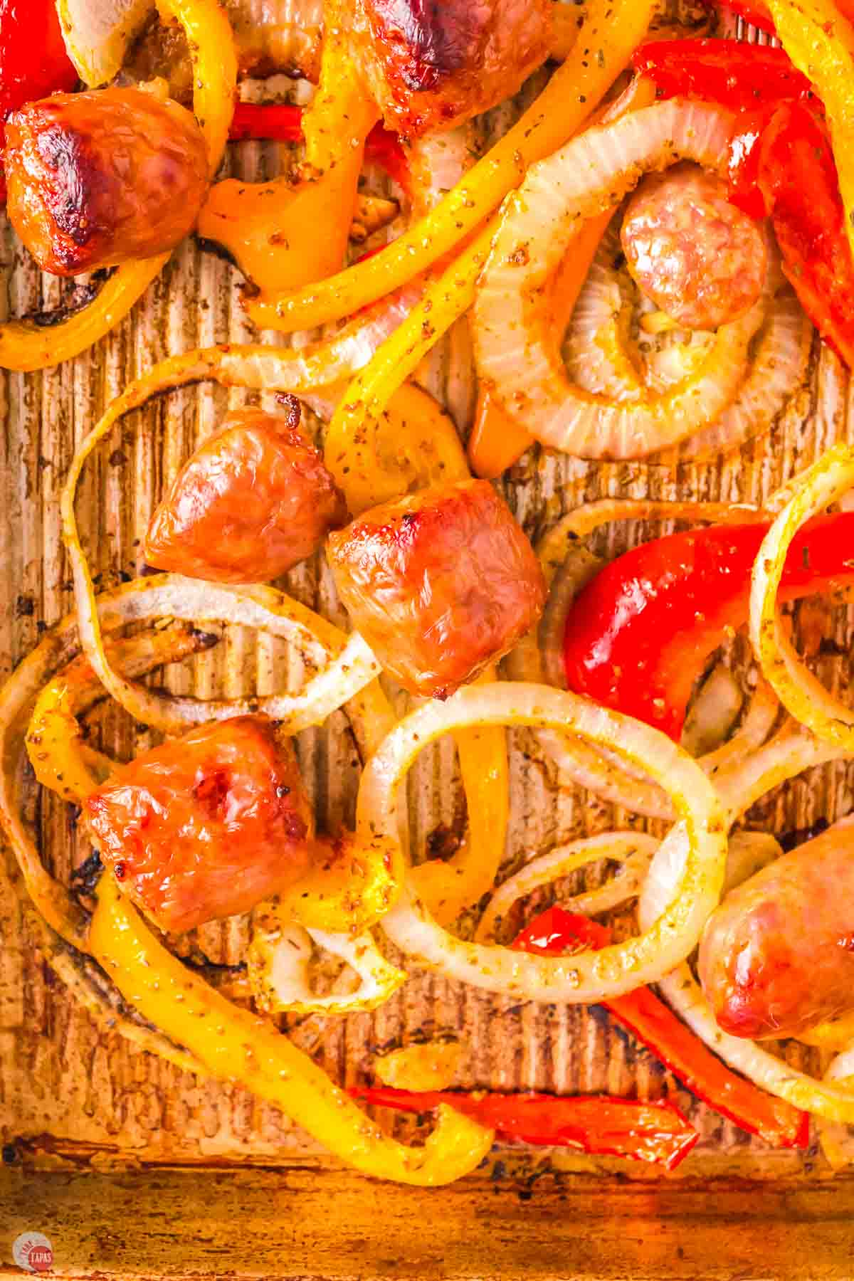 close up of sausage with red and yellow bell pepper strips
