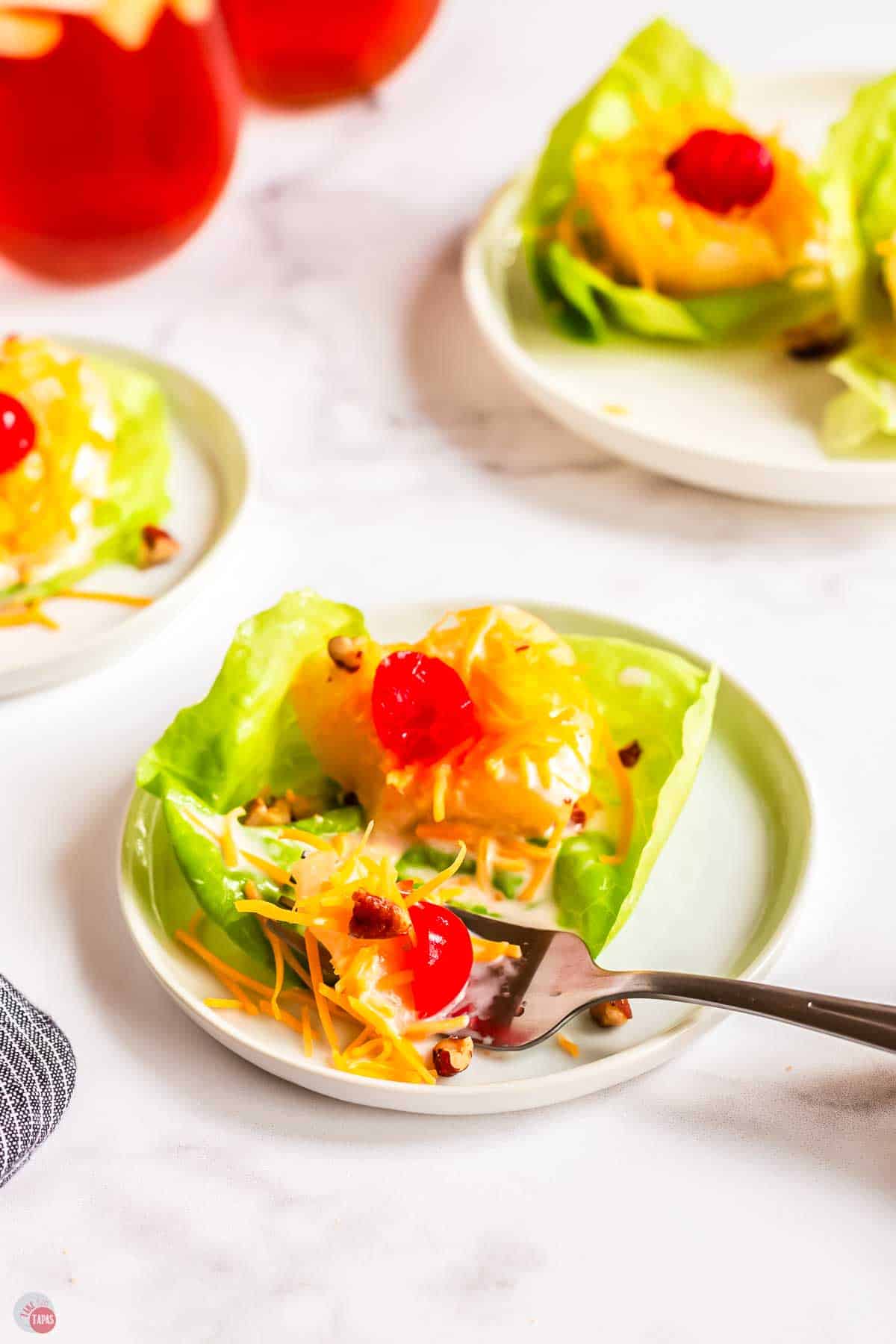 white plate with salad on it and a fork