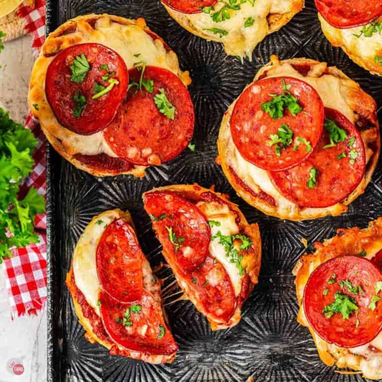 pepperoni pizza bagels on a black tray