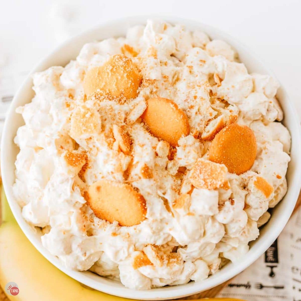 bowl of banana pudding fluff recipe with newspaper under it