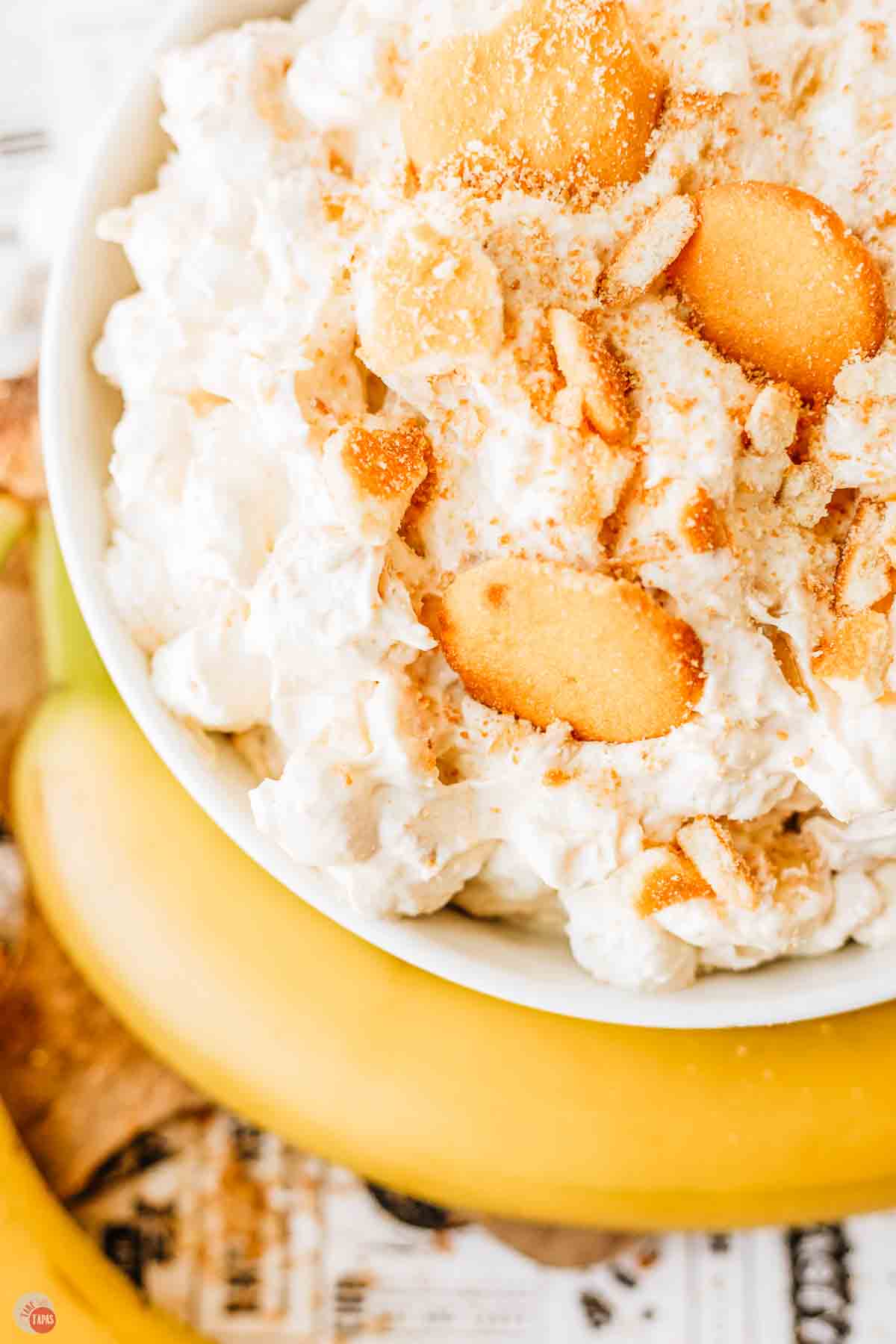 close up of whipped cream and vanilla wafers in a bowl