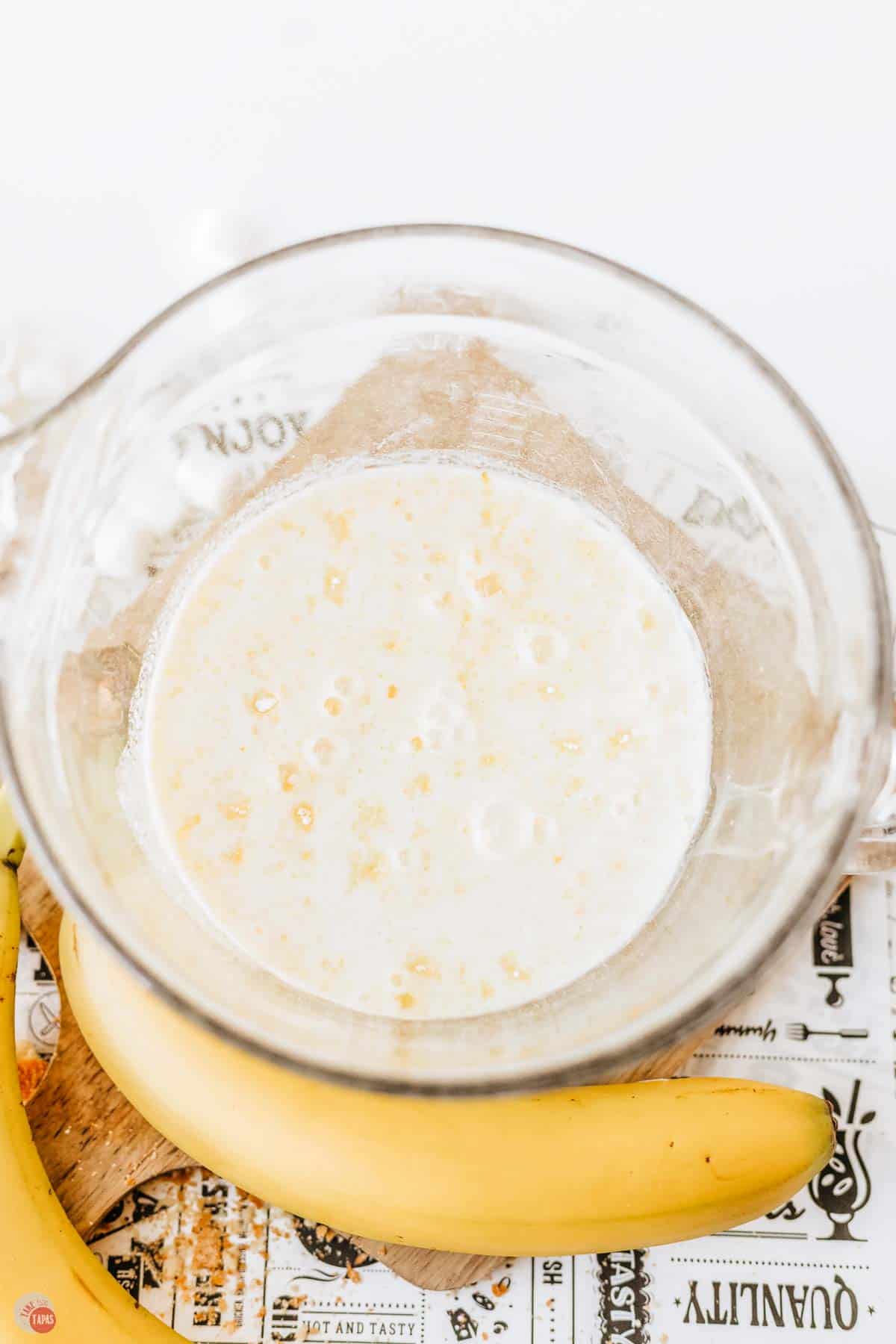 clear mixing bowl with pudding mix and milk in it