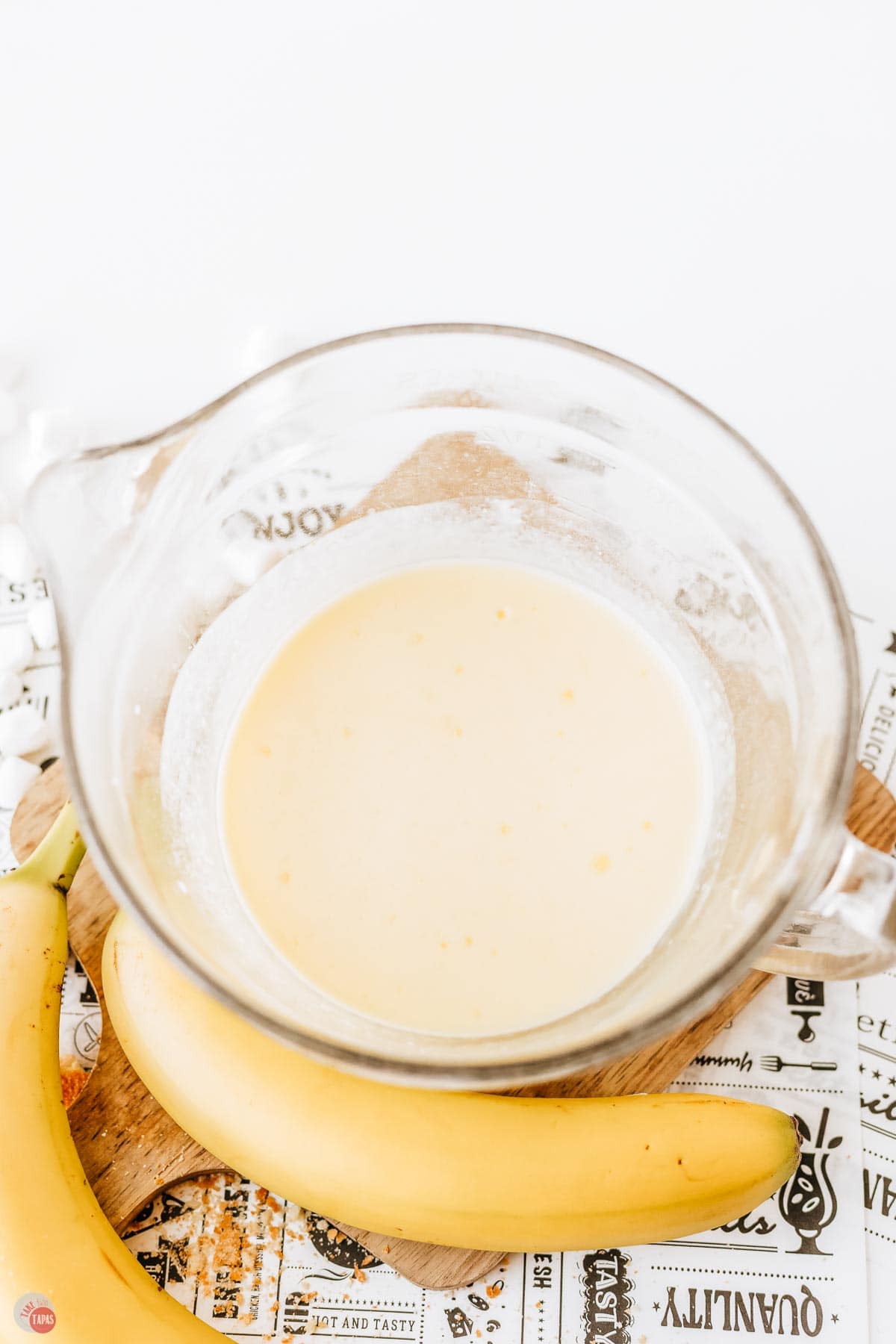 clear bowl on a wood board with pudding in it