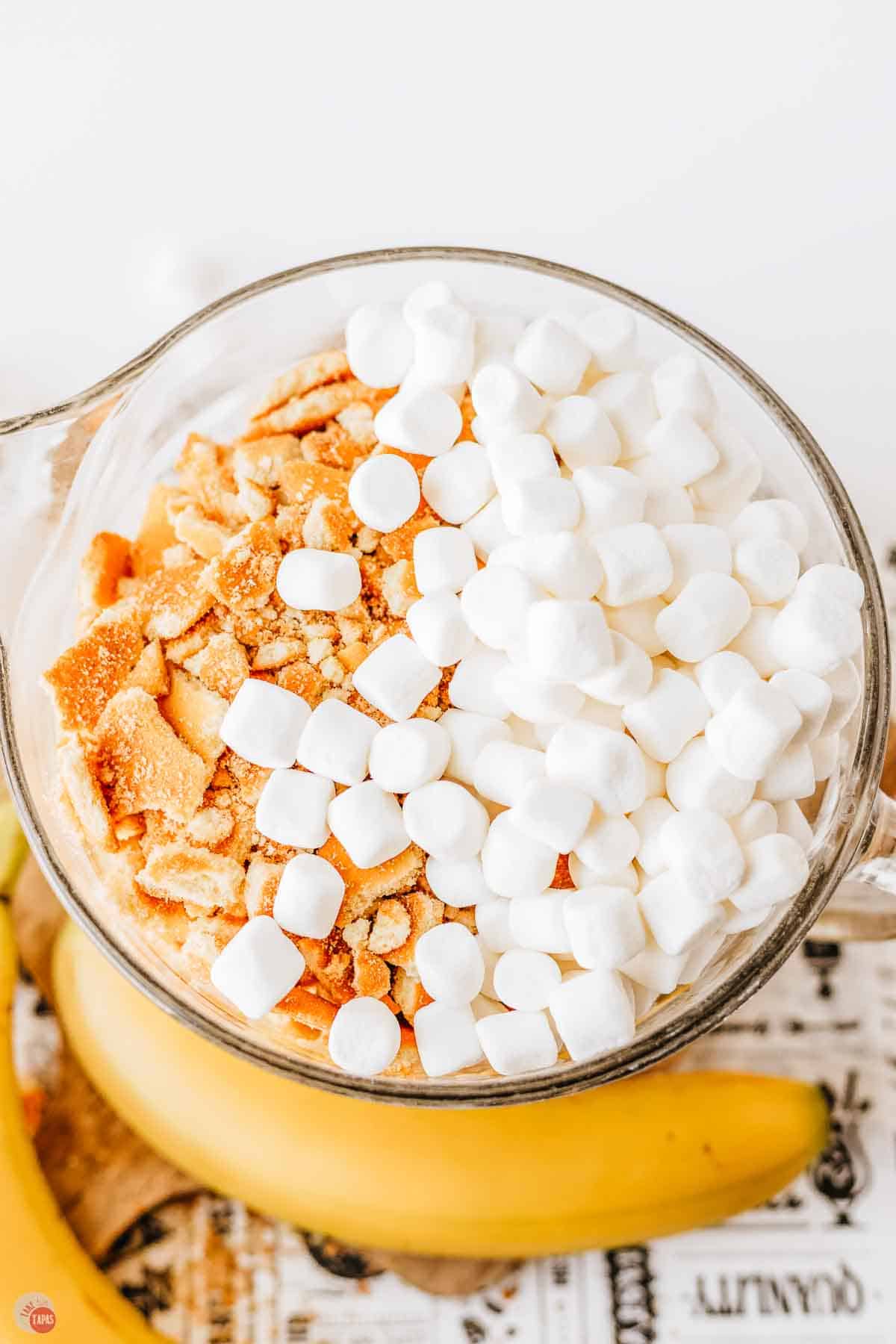 clear bowl with mini marshmallows and crushed vanilla wafers on top