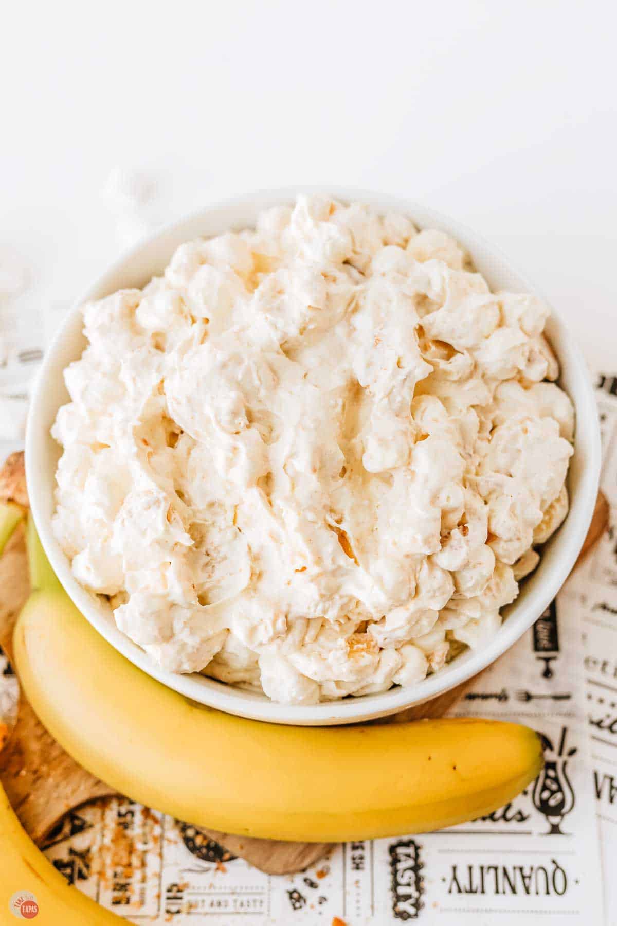 bowl of banana marshmallow salad in it with a banana next to it