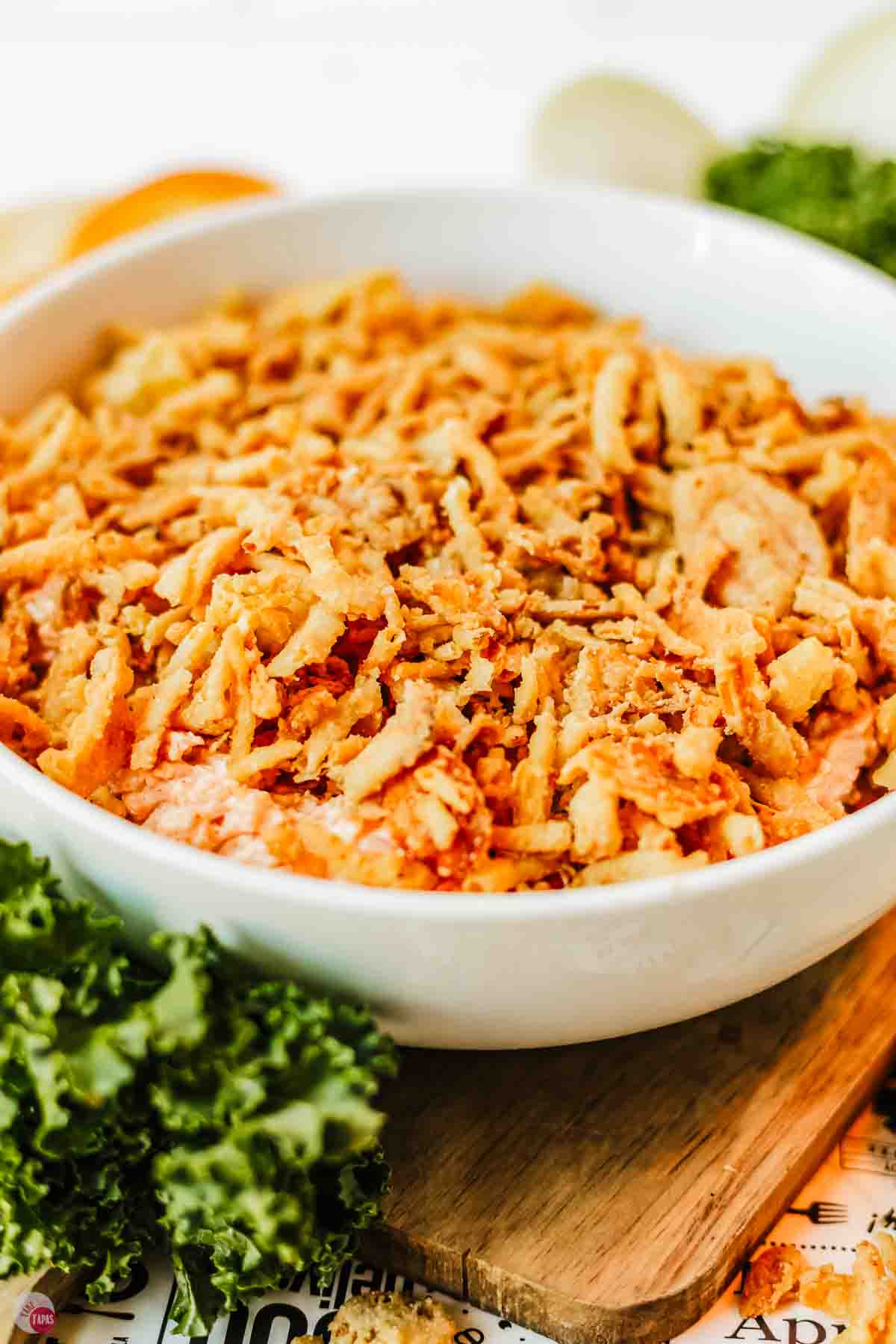 side view of white bowl with fried onions in it