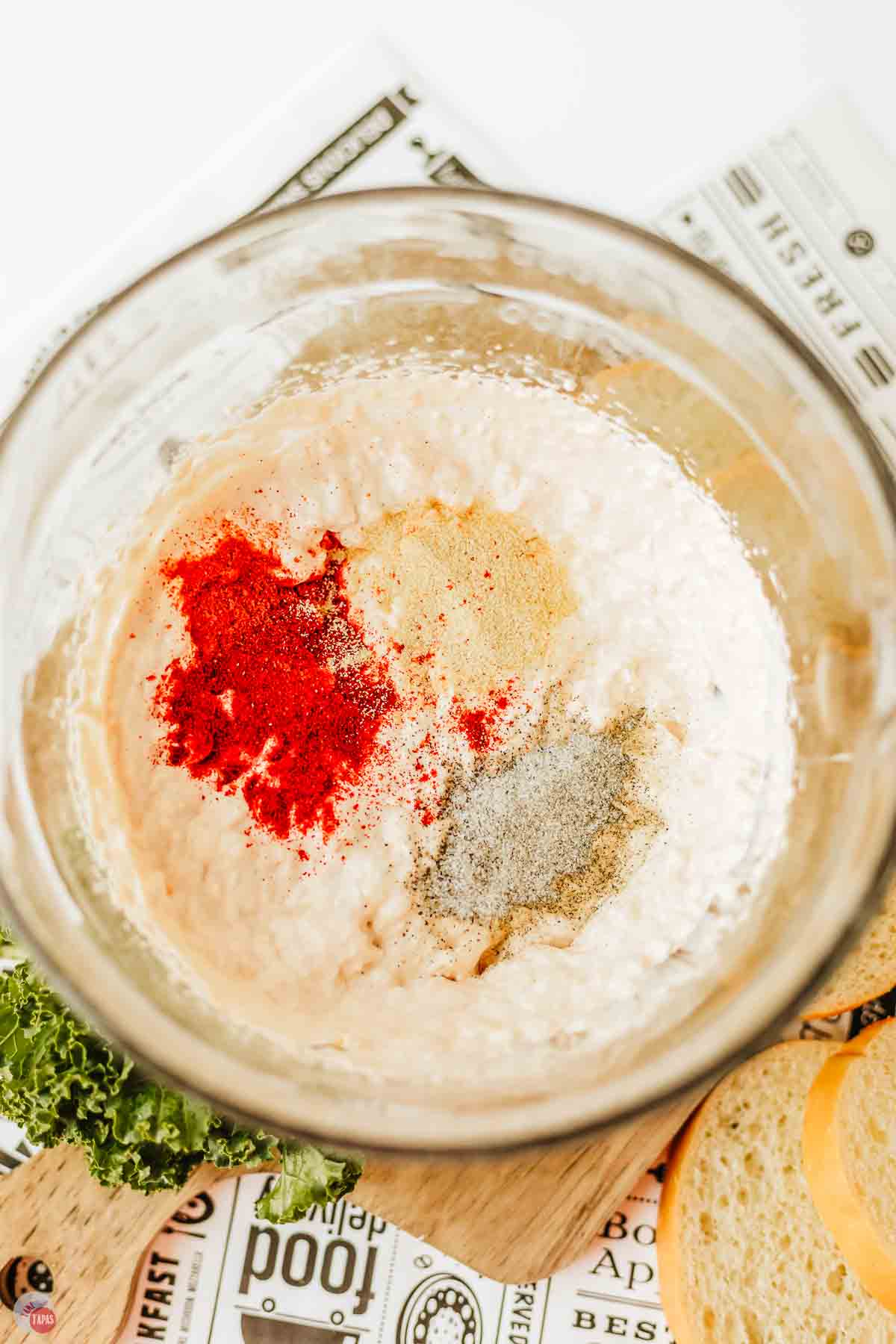 cream cheese and spices in a clear mixing bowl
