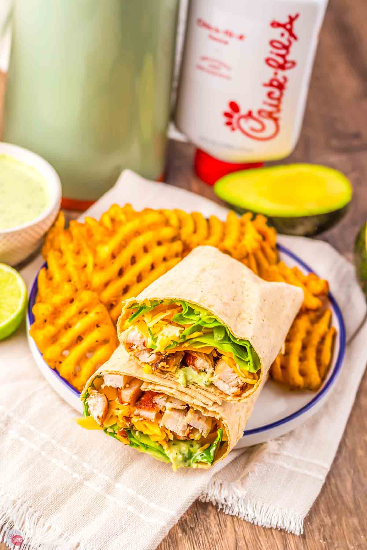 overhead pic of plate with  some waffle fries and a chicken wrap