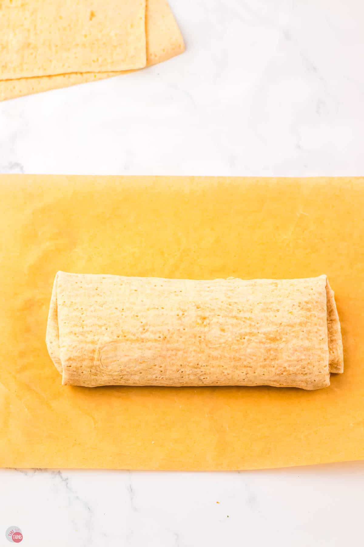 whole wheat wrap on a piece of parchment paper