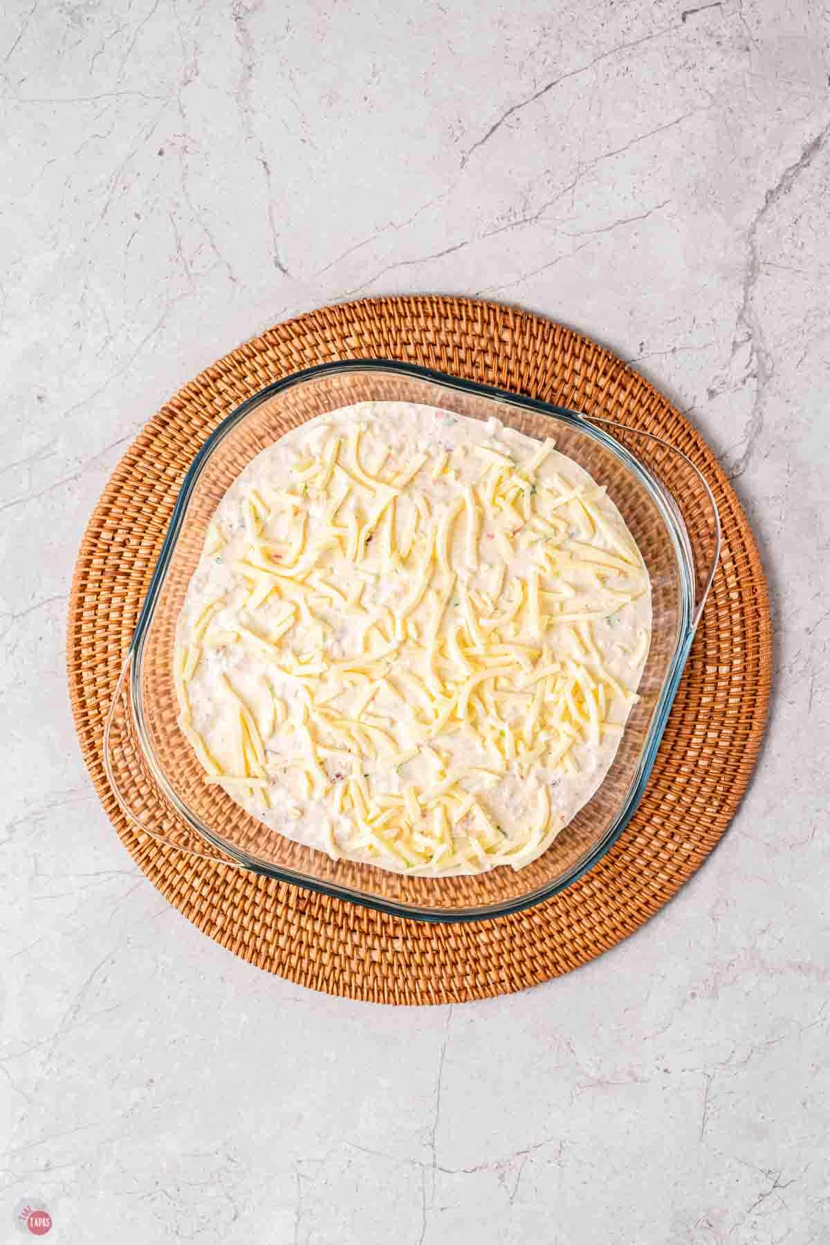 wood circle platter with clear bowl filled with dip on it