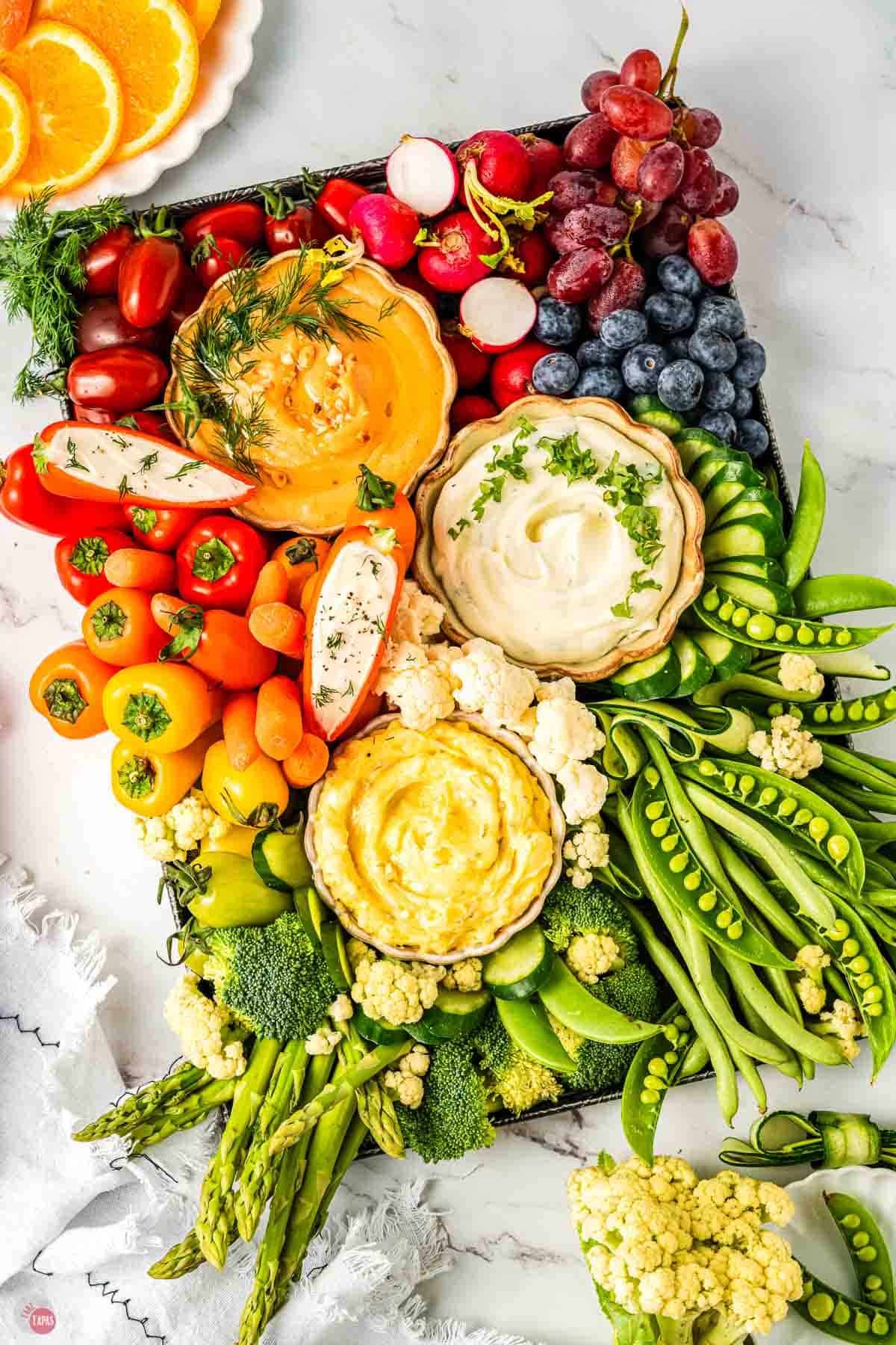 angled crudite platter with fresh vegetables and dips