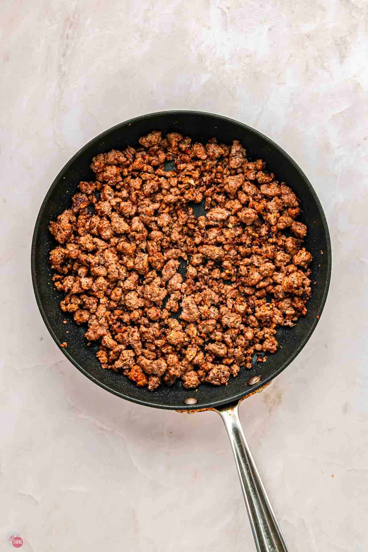 cooked, season ground beef in a skillet