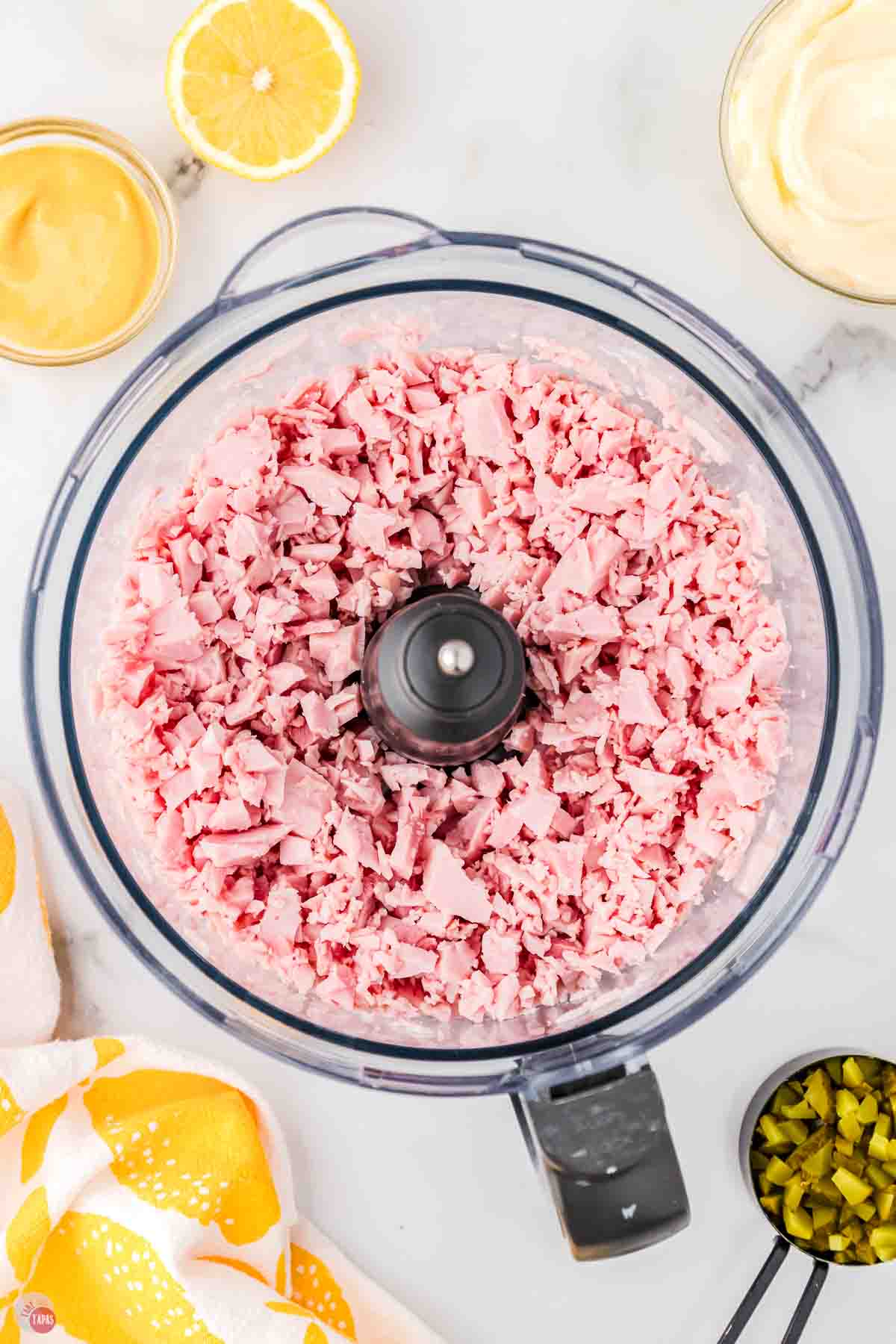 food processor bowl with chopped ham in it