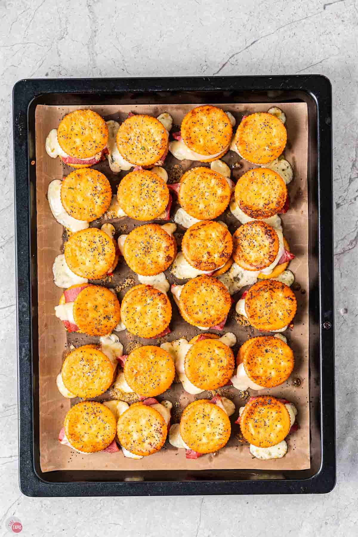 baked cracker sliders on a piece of parchment paper