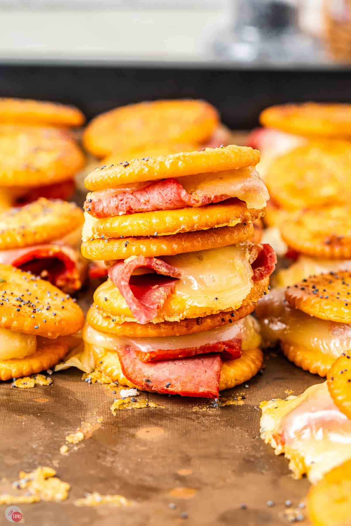 stack of crackers filled with meat and cheese
