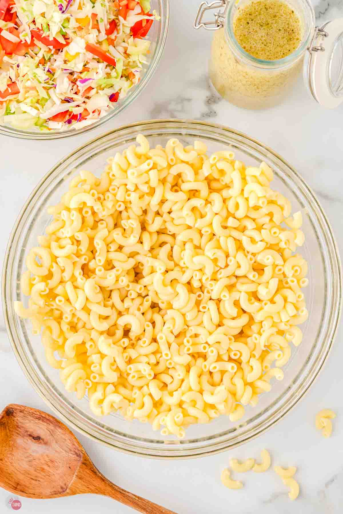 cooked elbow macaroni noodles in a clear bowl