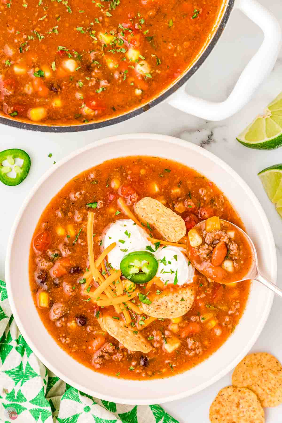 bowl of taco soup with a spoon next to a large pot