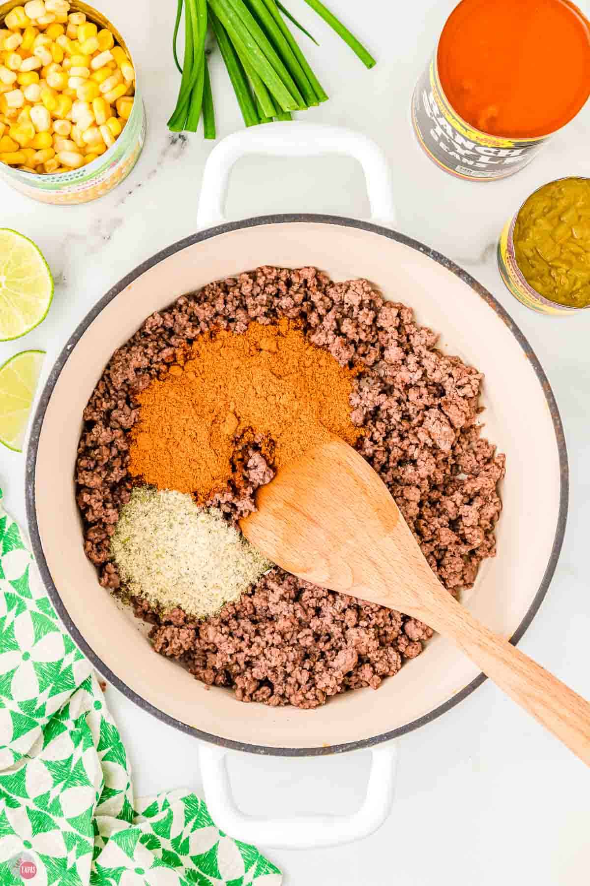 cooked ground beef in a pot with two spices on top