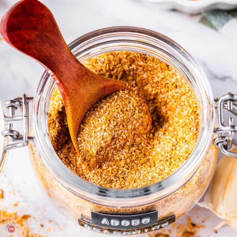 jar of adobo seasoning with a small wood spoon