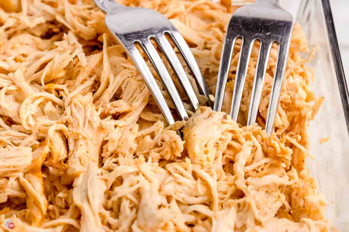 two forks shredding meat