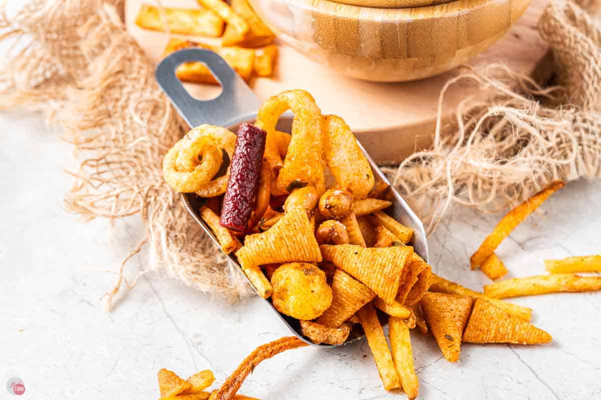 metal scoop full of bar snack mix