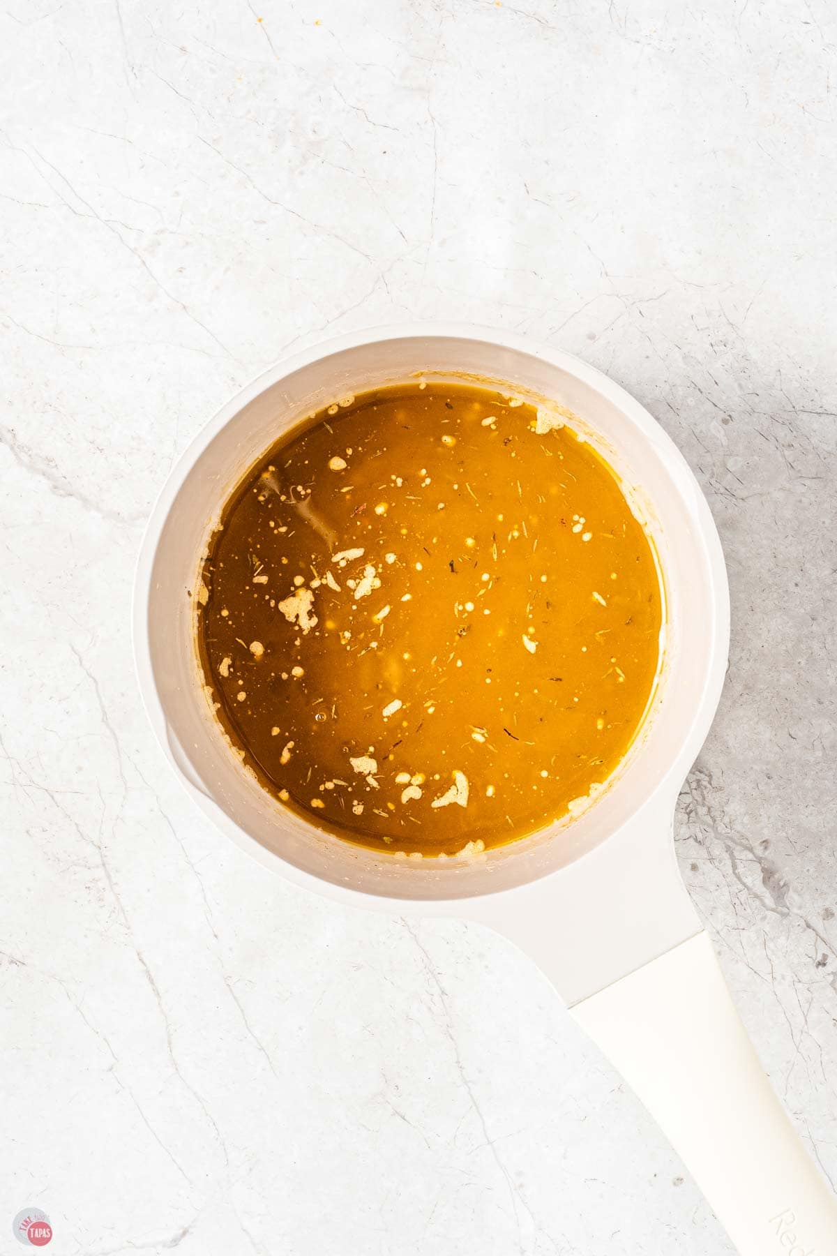 white bowl of melted butter and spices