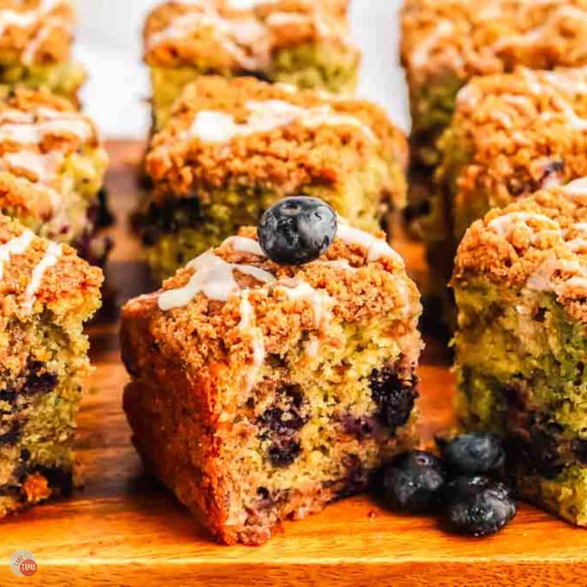 slices of blueberry coffee cake on a wood board