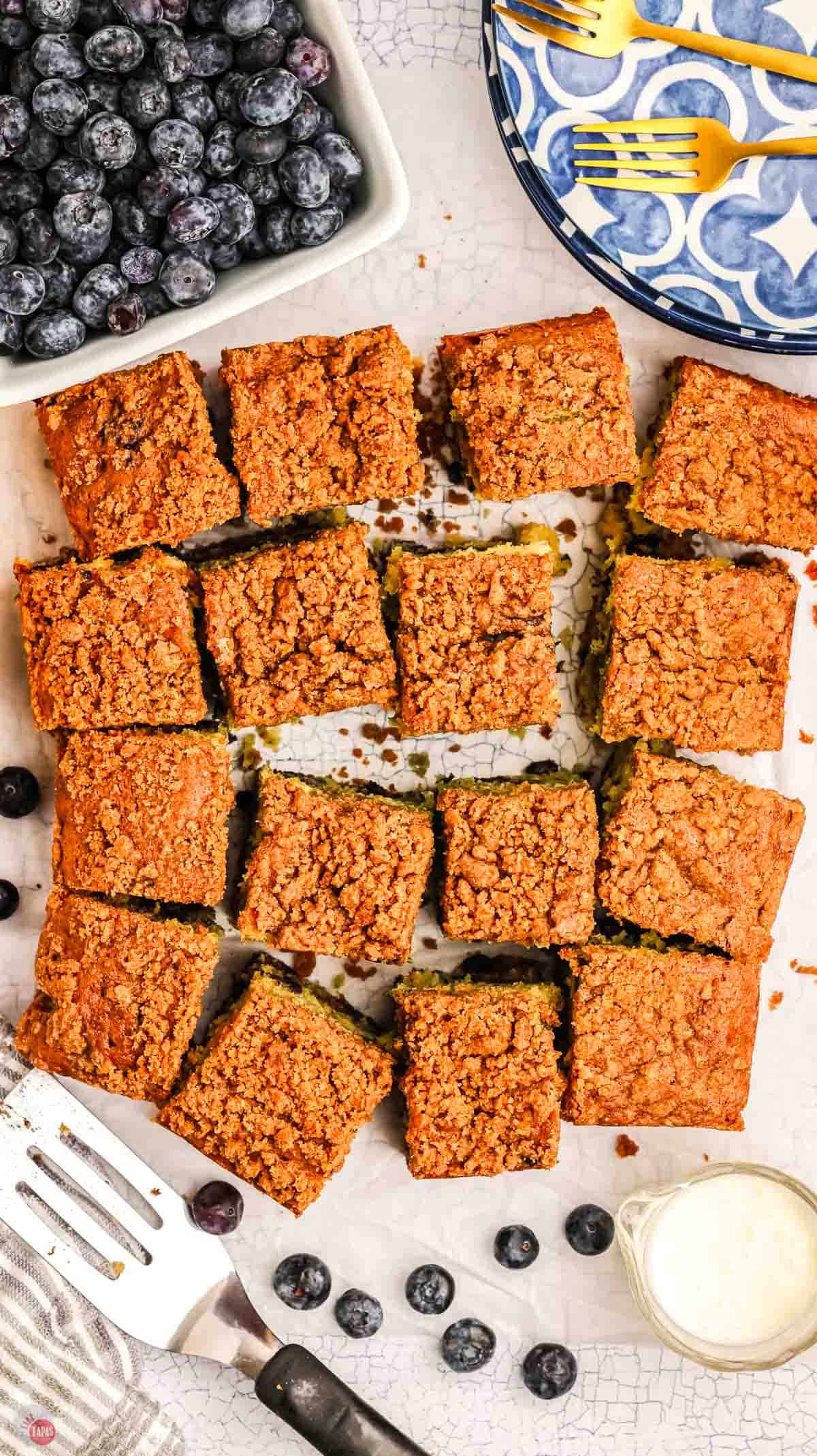 baked coffee cake, cut into squares on a piece of parchment paper