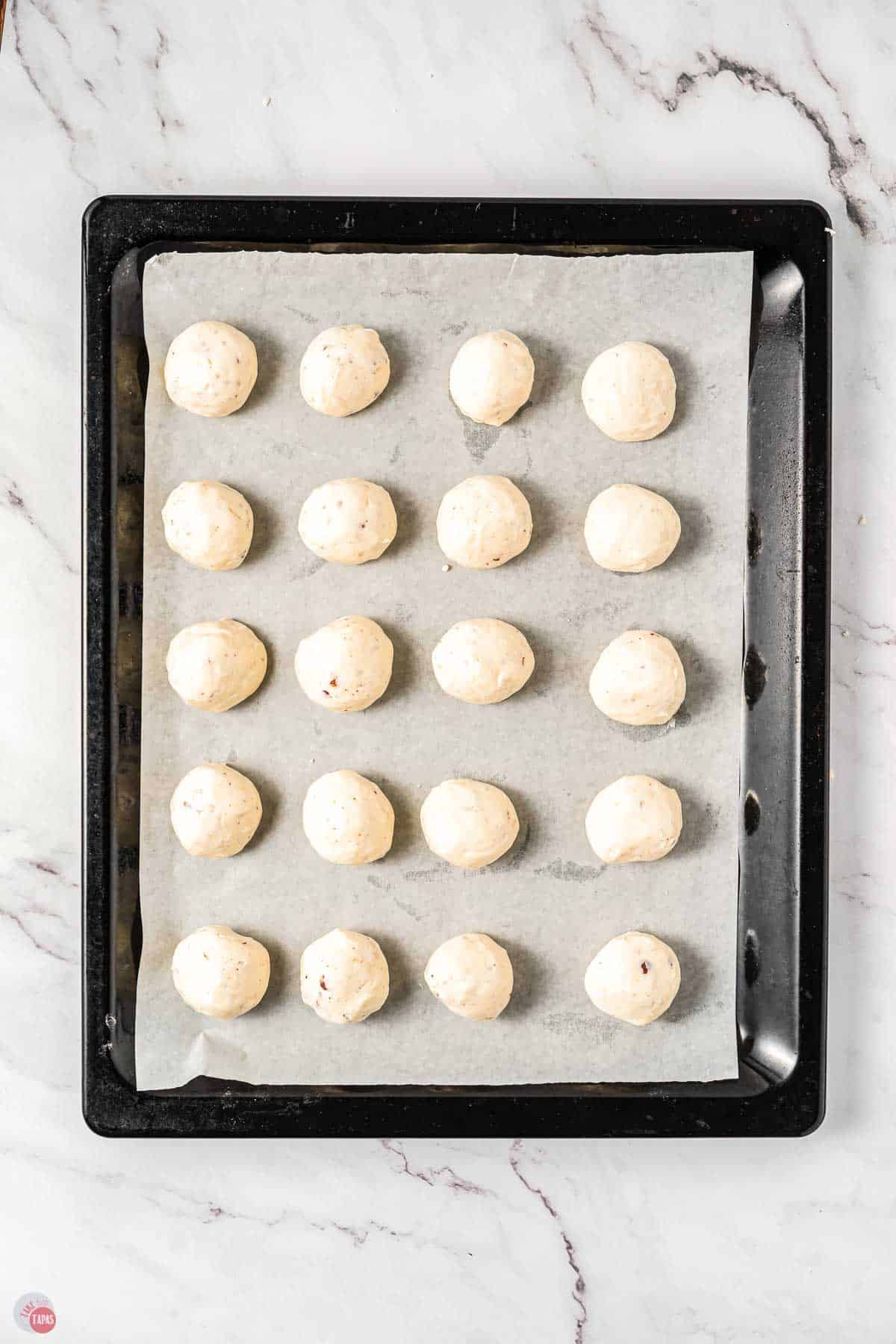 bourbon ball on a baking sheet with parchment paper