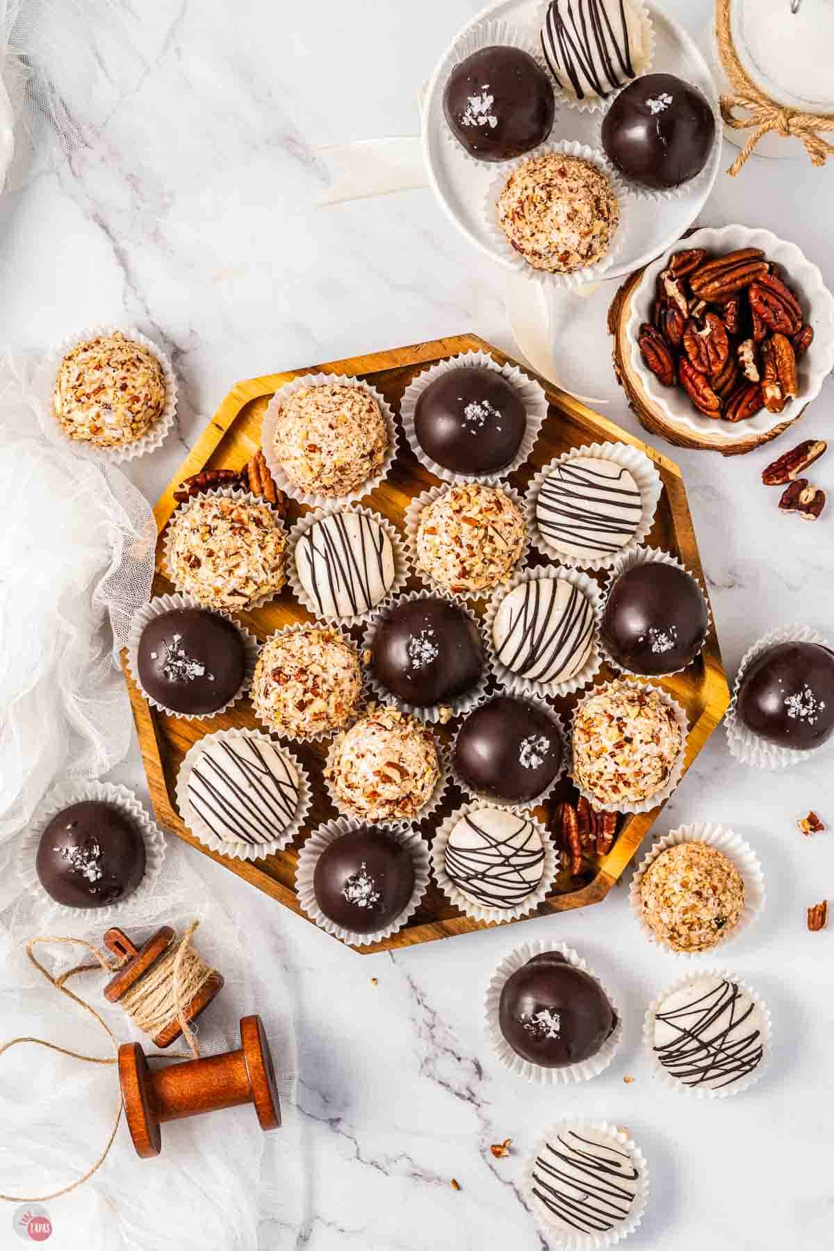 platter of bourbon balls with drizzles and toasted pecans