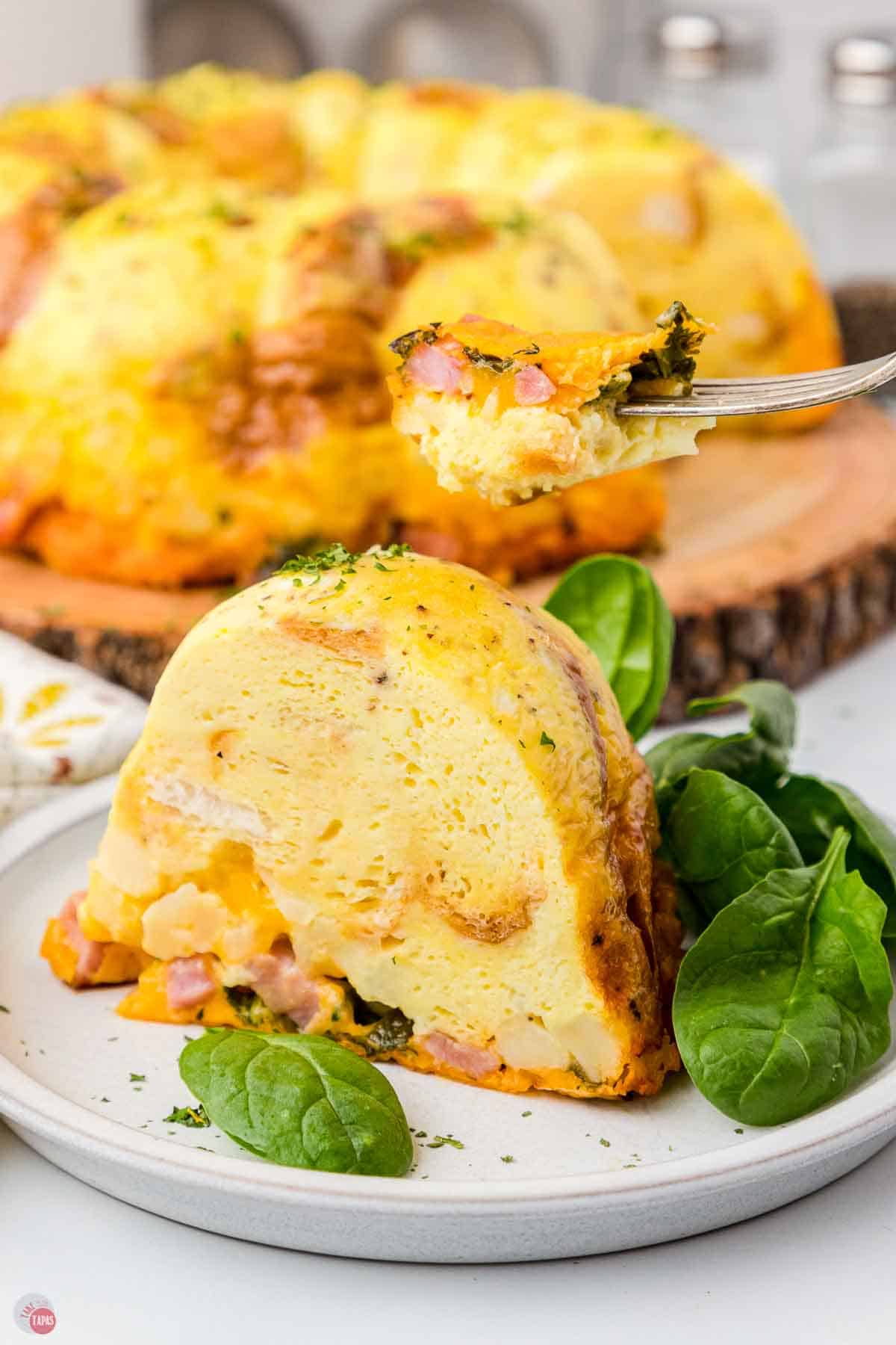 fork with bite of eggs over a plate