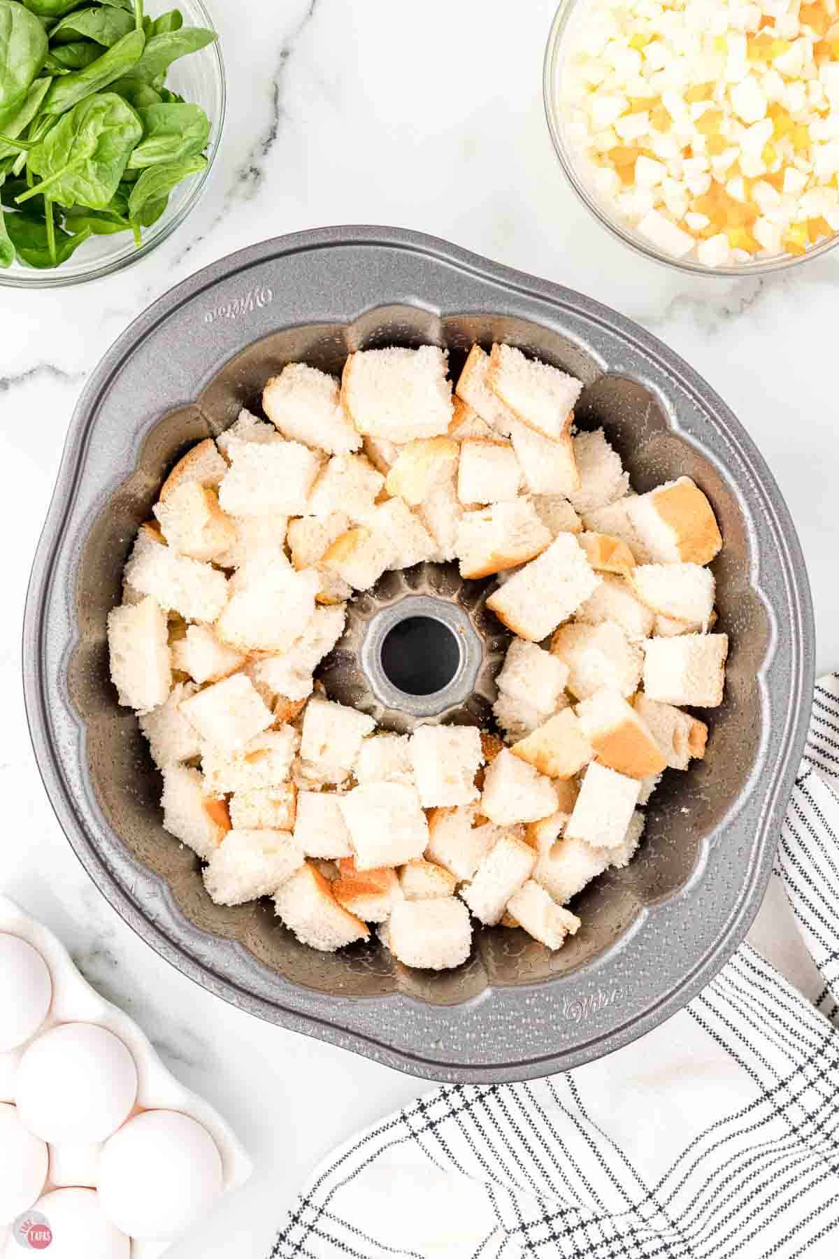 cubed bread in a bundt pan