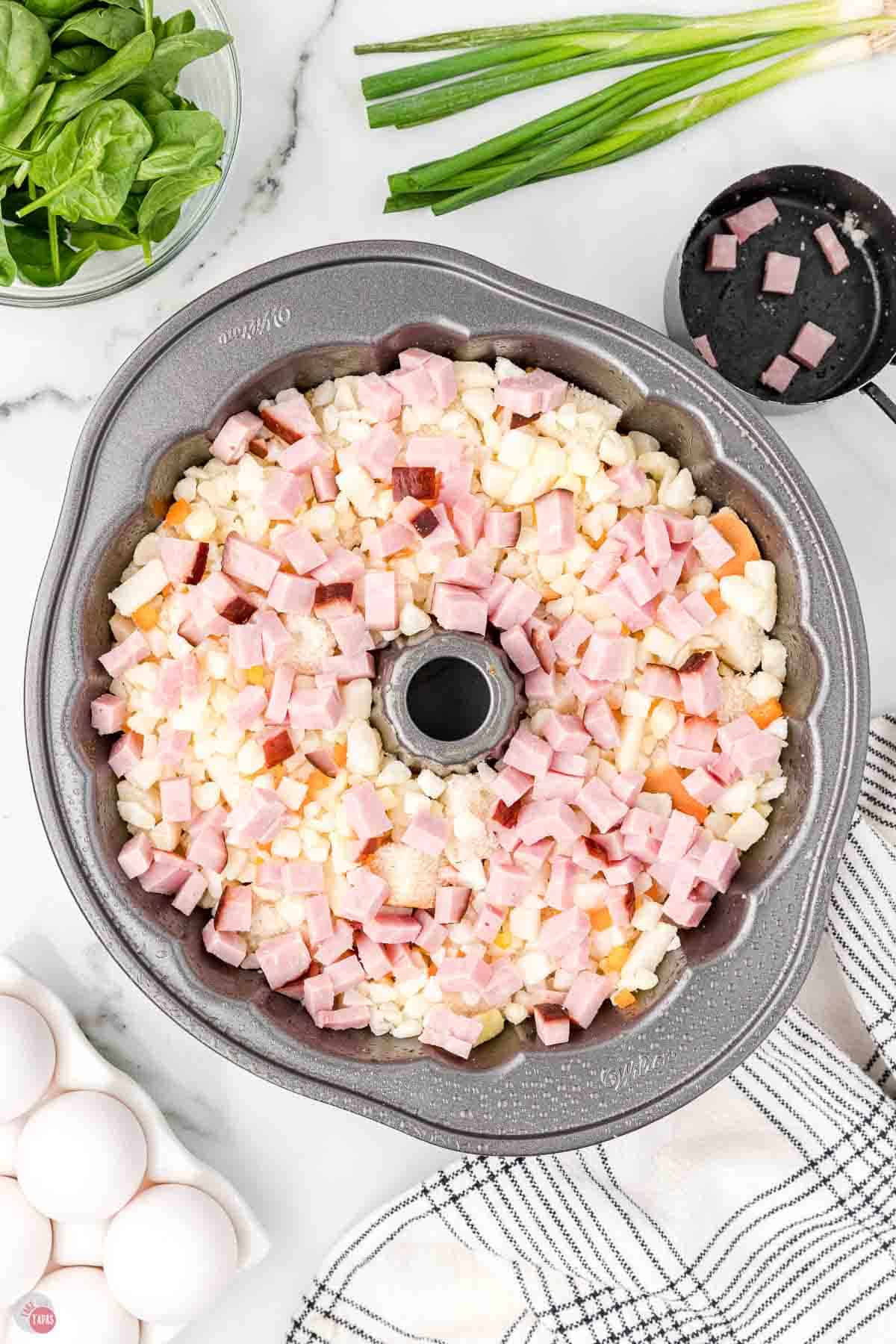 bundt pan with diced potatoes and ham