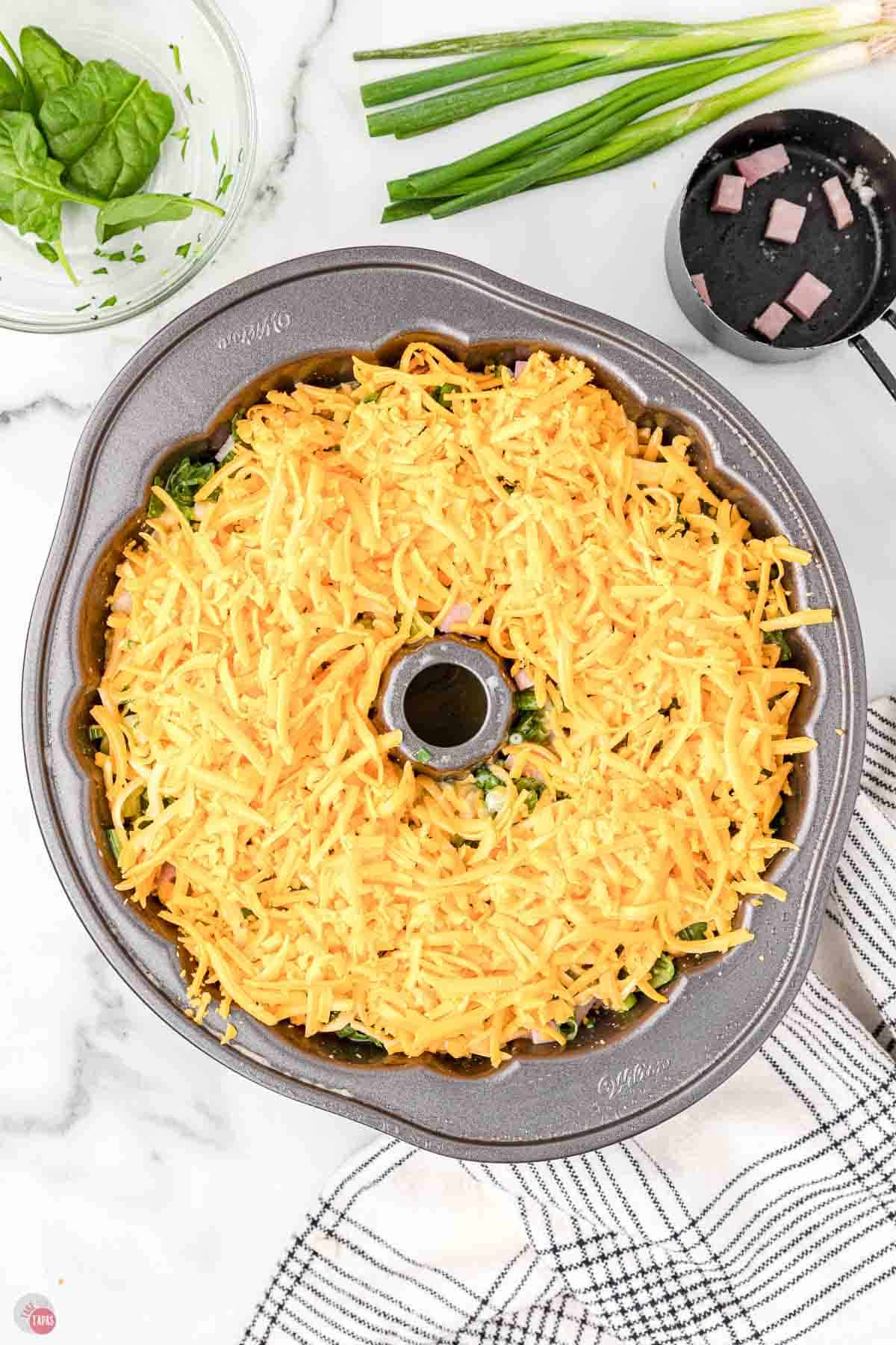 bundt pan filled with shredded cheese