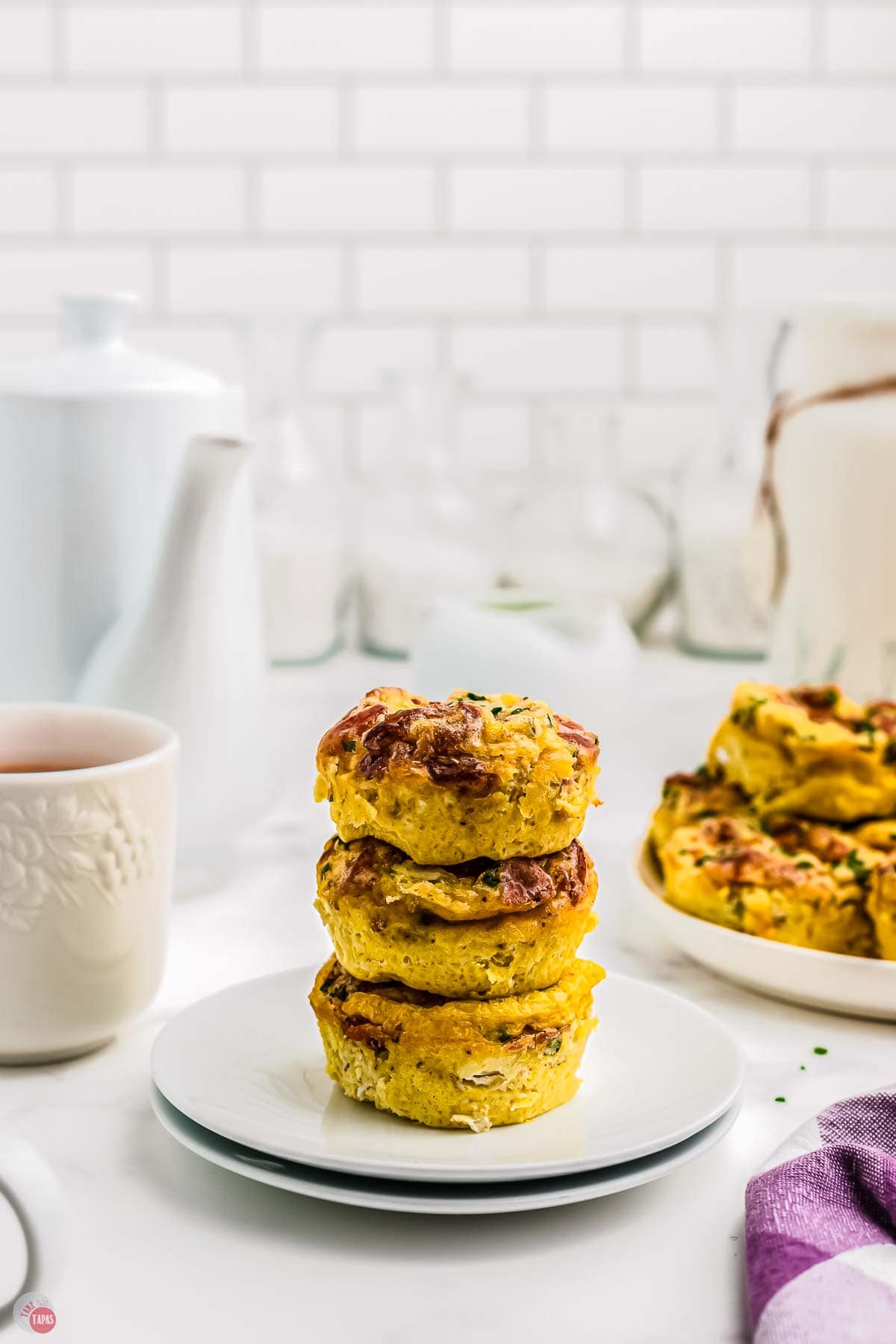 stack of three egg muffins on a white plate