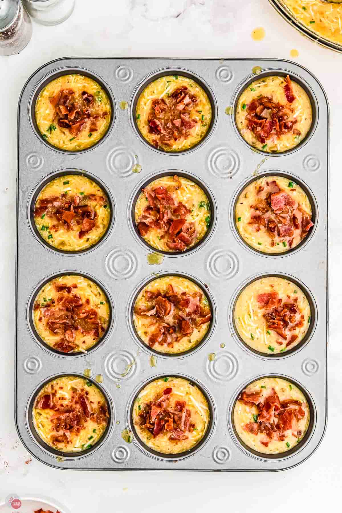 unbaked egg muffins for breakfast in a muffin pan