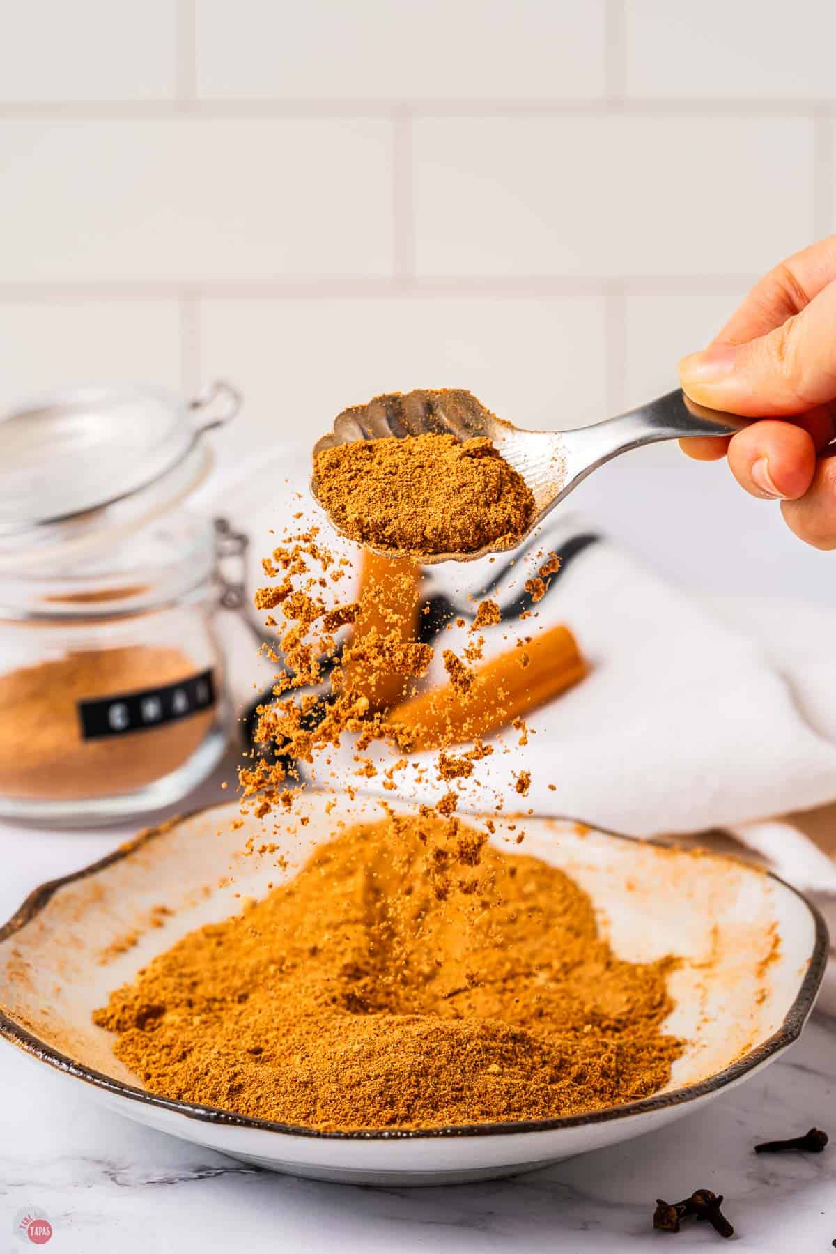 spoon scooping chai mix out of a plate