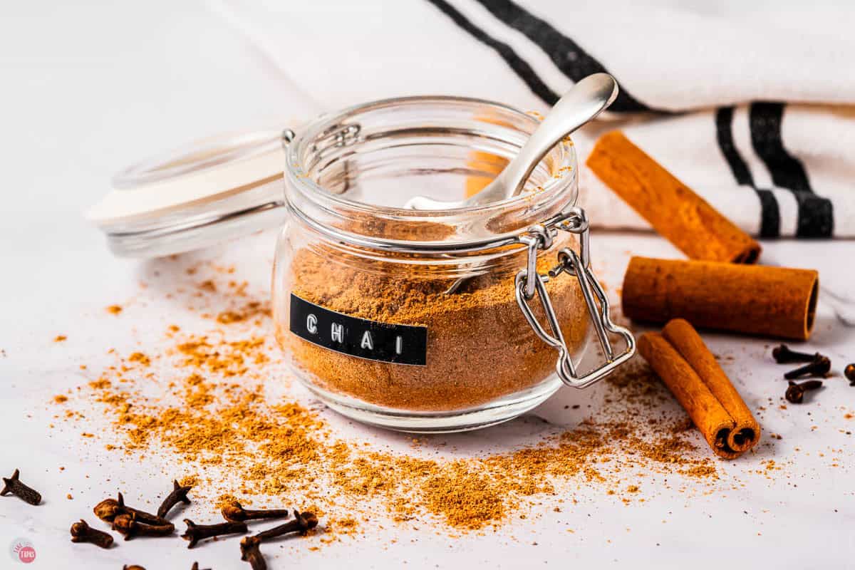 clear jar with spices and a spoon with some spilled out