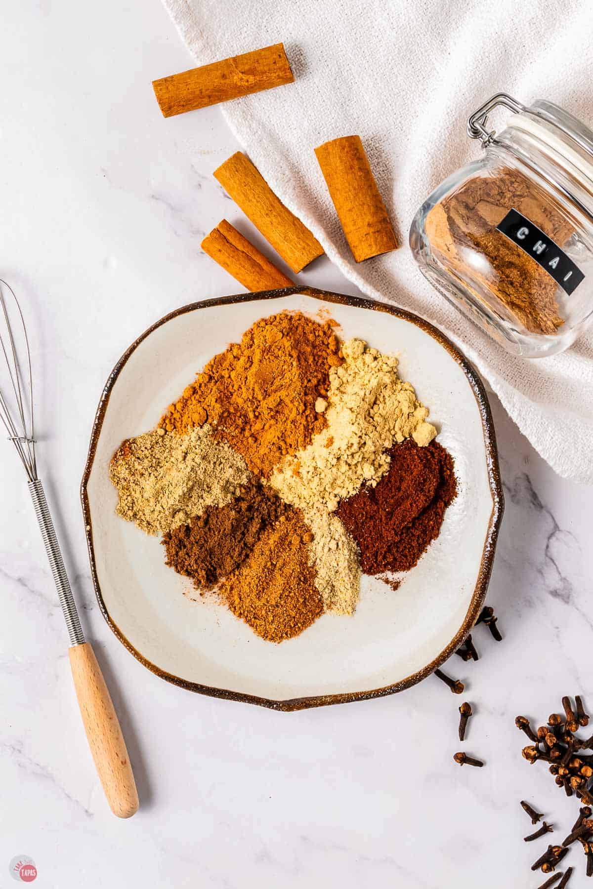 individual spices on a ceramic plate