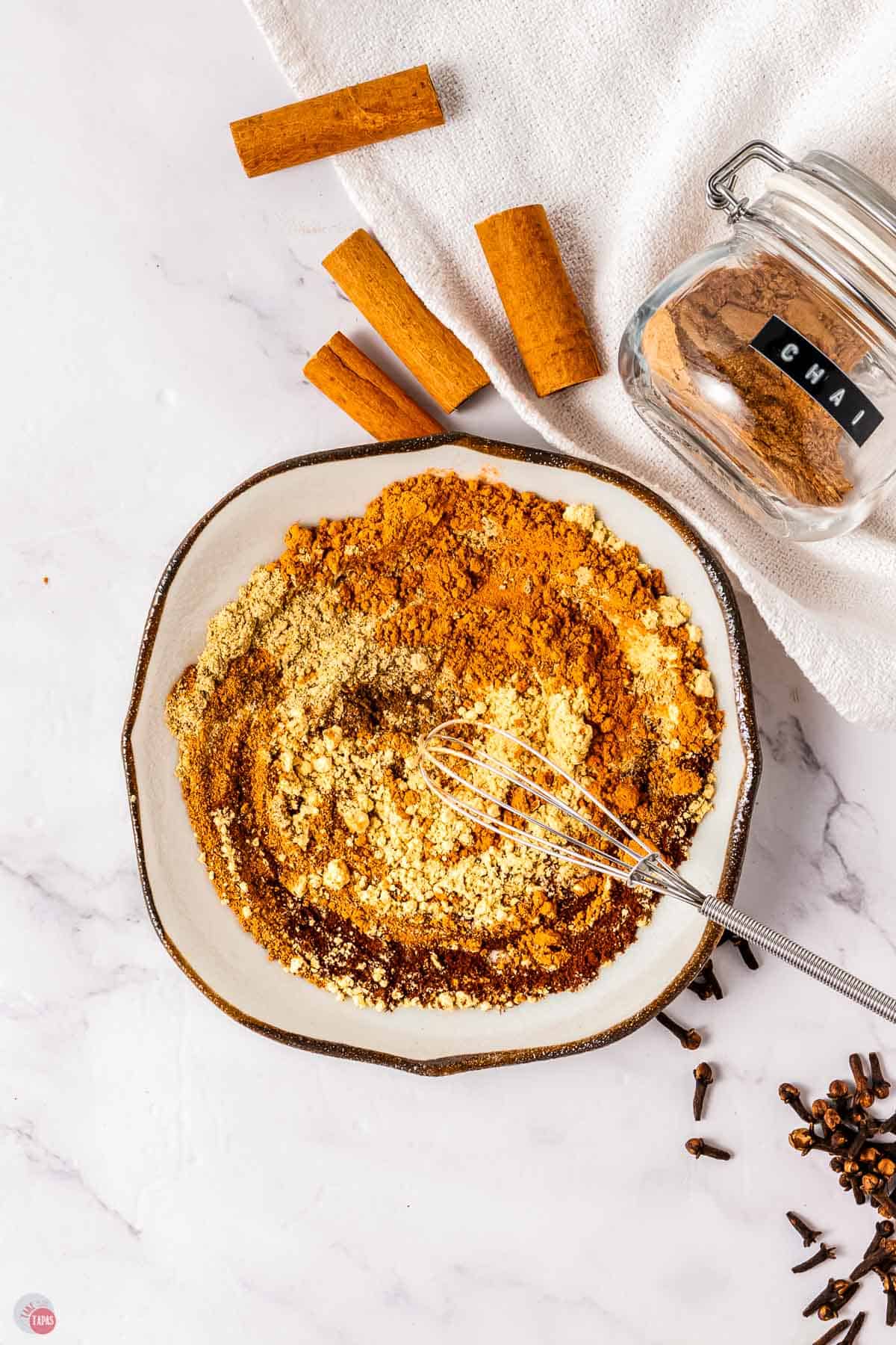 spices on a plate being whisked together