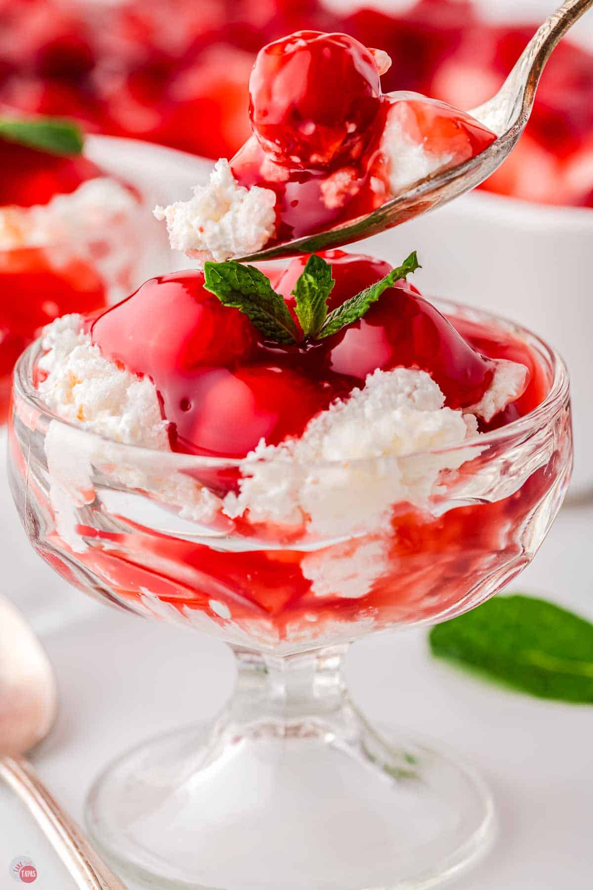 small parfait glass with cherry dessert and a spoon